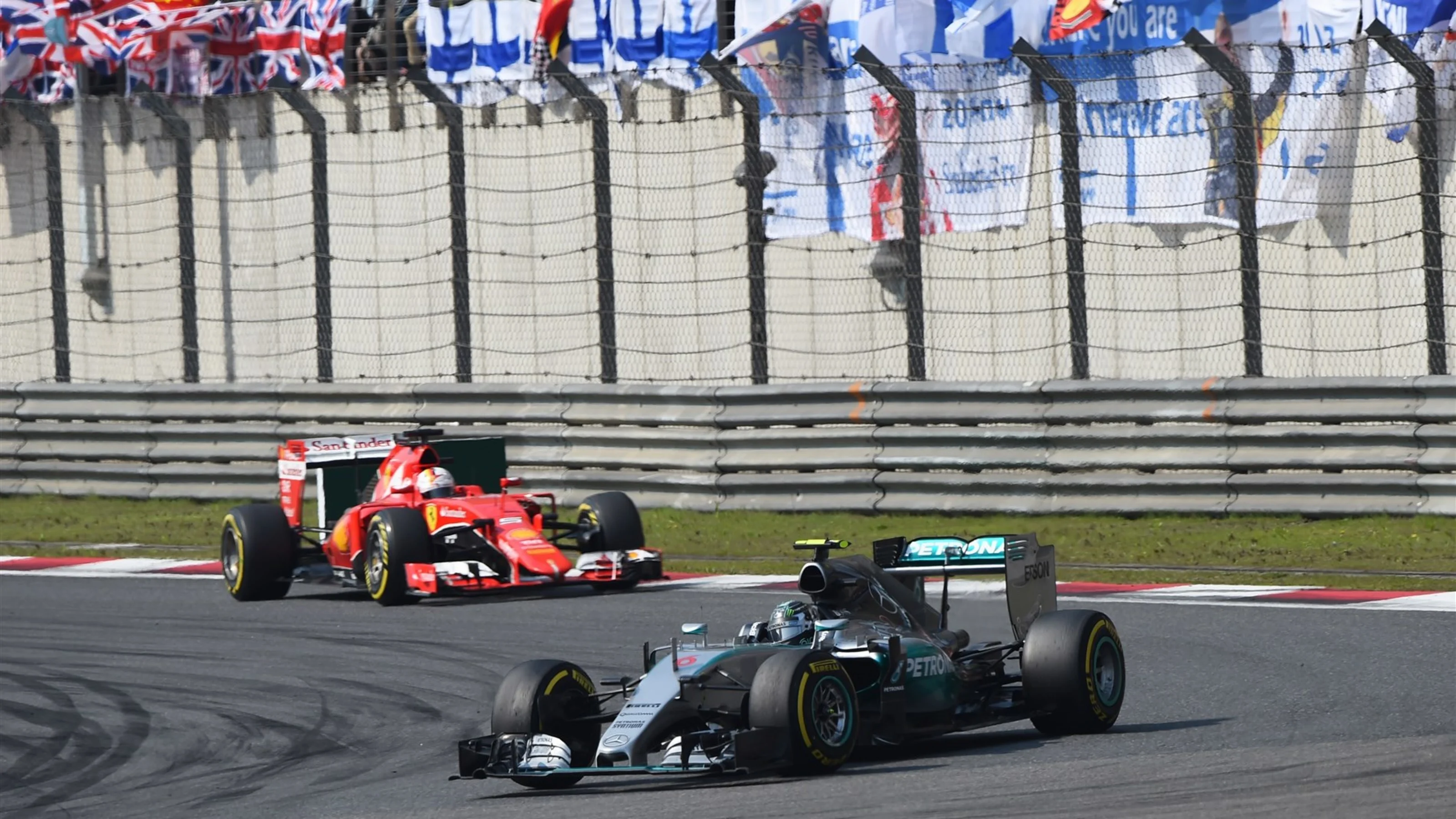 Nico Rosberg (GER) Mercedes AMG F1 W06 leads Sebastian Vettel (GER) Ferrari SF15-T at Formula One