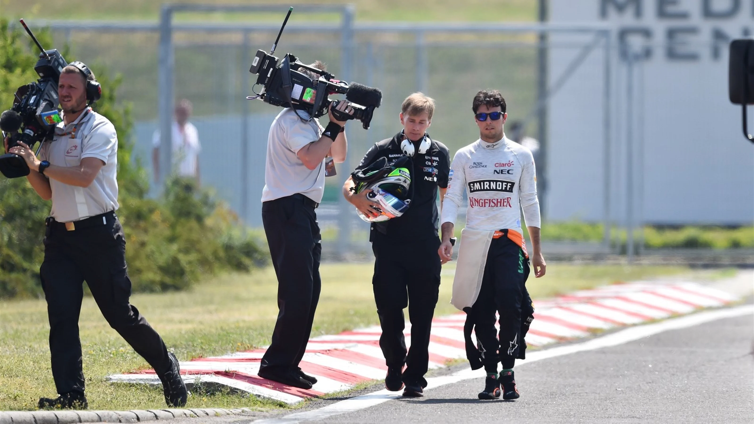 Sergio Perez (MEX) Force India walks in with his trainer Xavi Martos (ESP) after crashing and