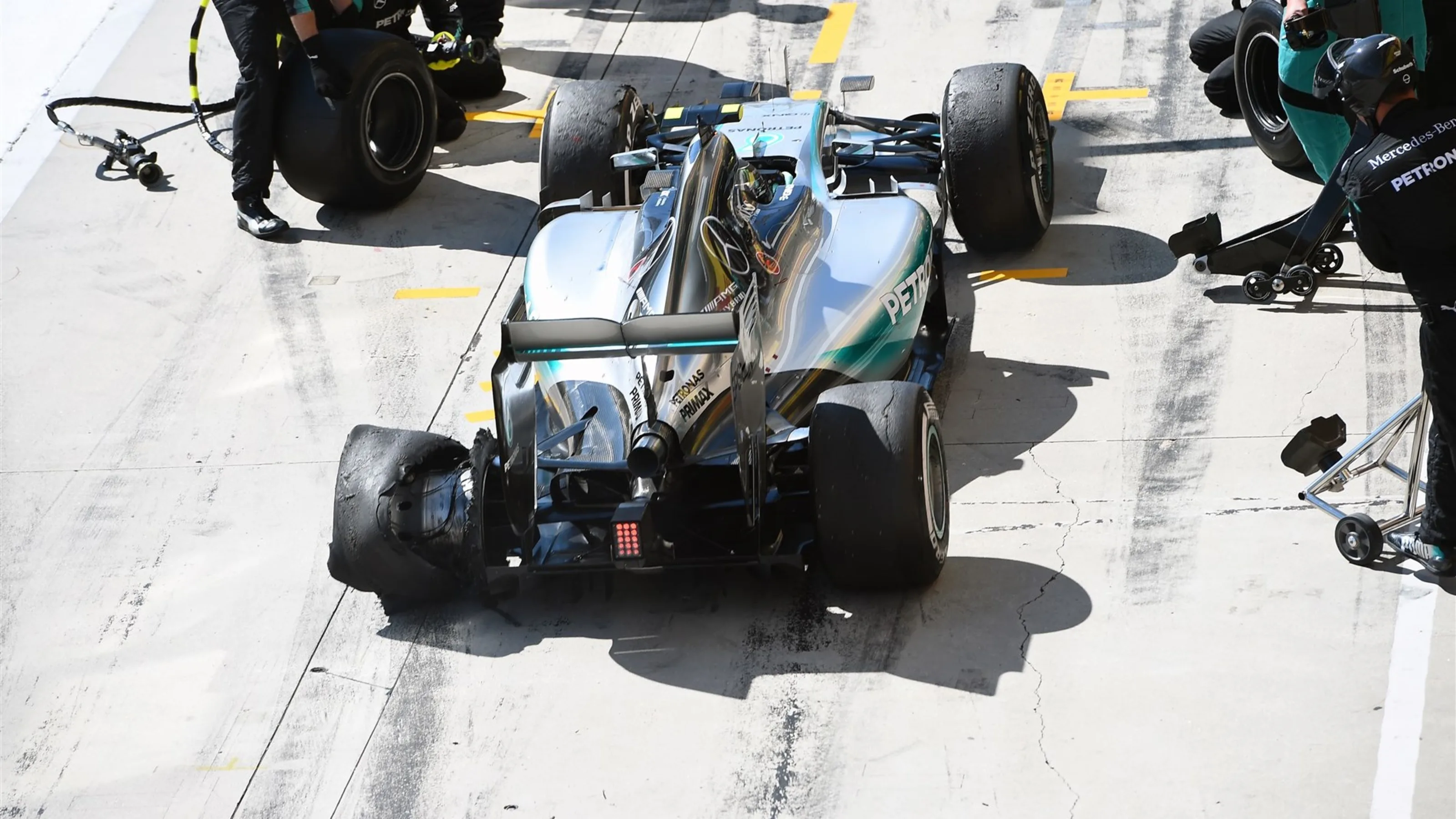 Nico Rosberg (GER) Mercedes AMG F1 W06 enters the pits with a punctured rear tyre at Formula One