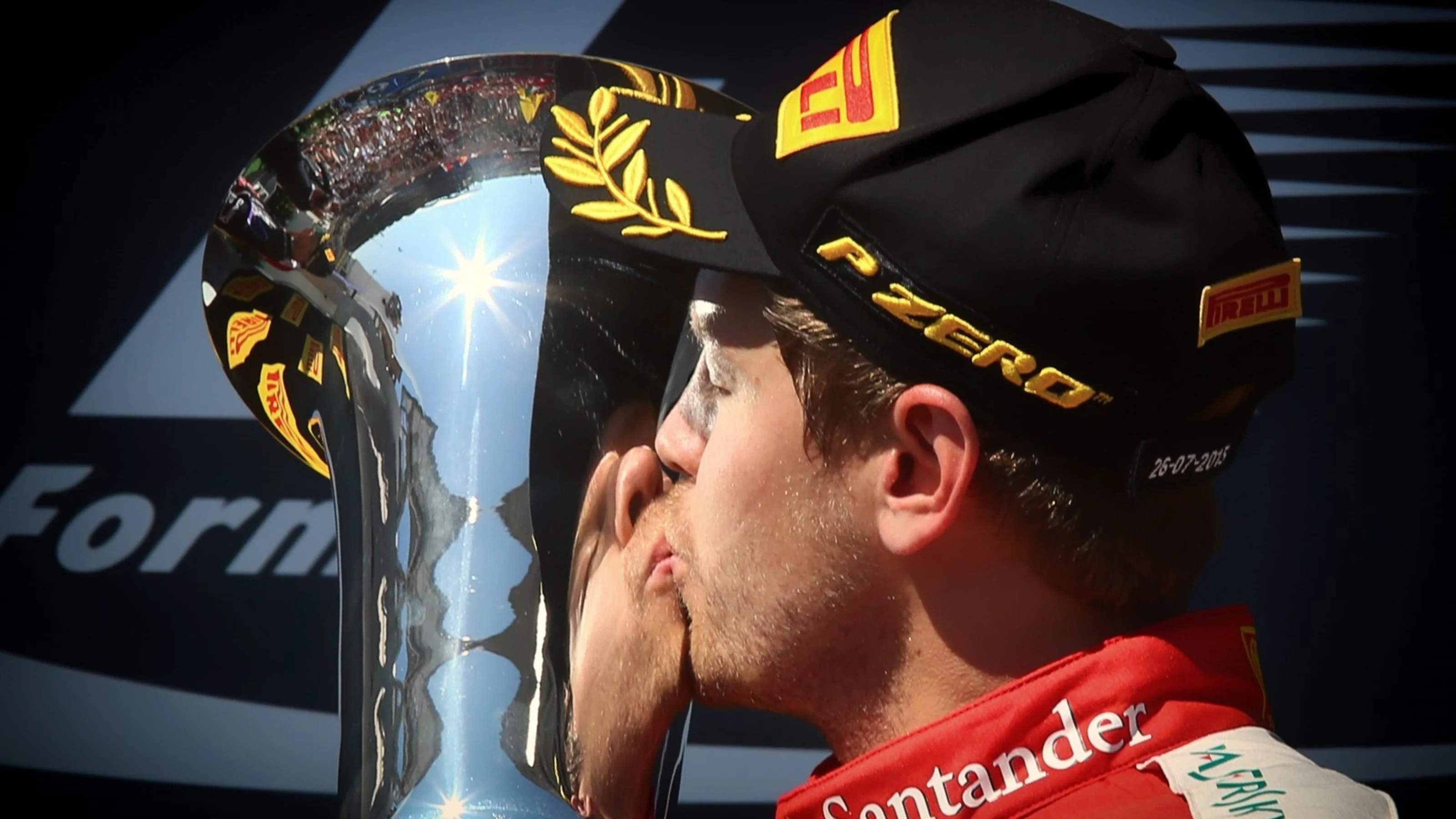 Race winner Sebastian Vettel (GER) Ferrari celebrates and kisses the trophy on the podium at