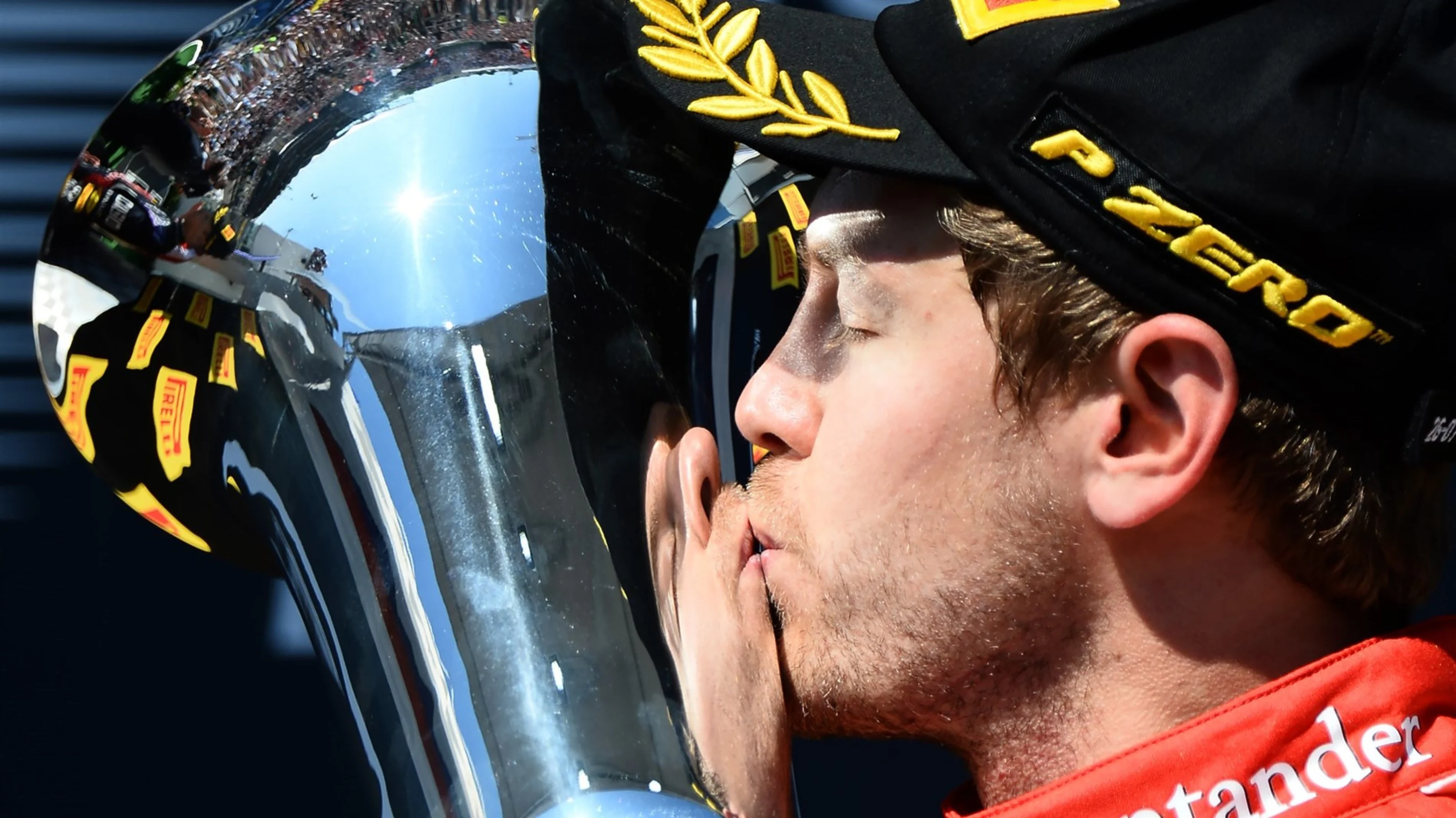 Race winner Sebastian Vettel (GER) Ferrari kisses the trophy on the Podium at Formula One World