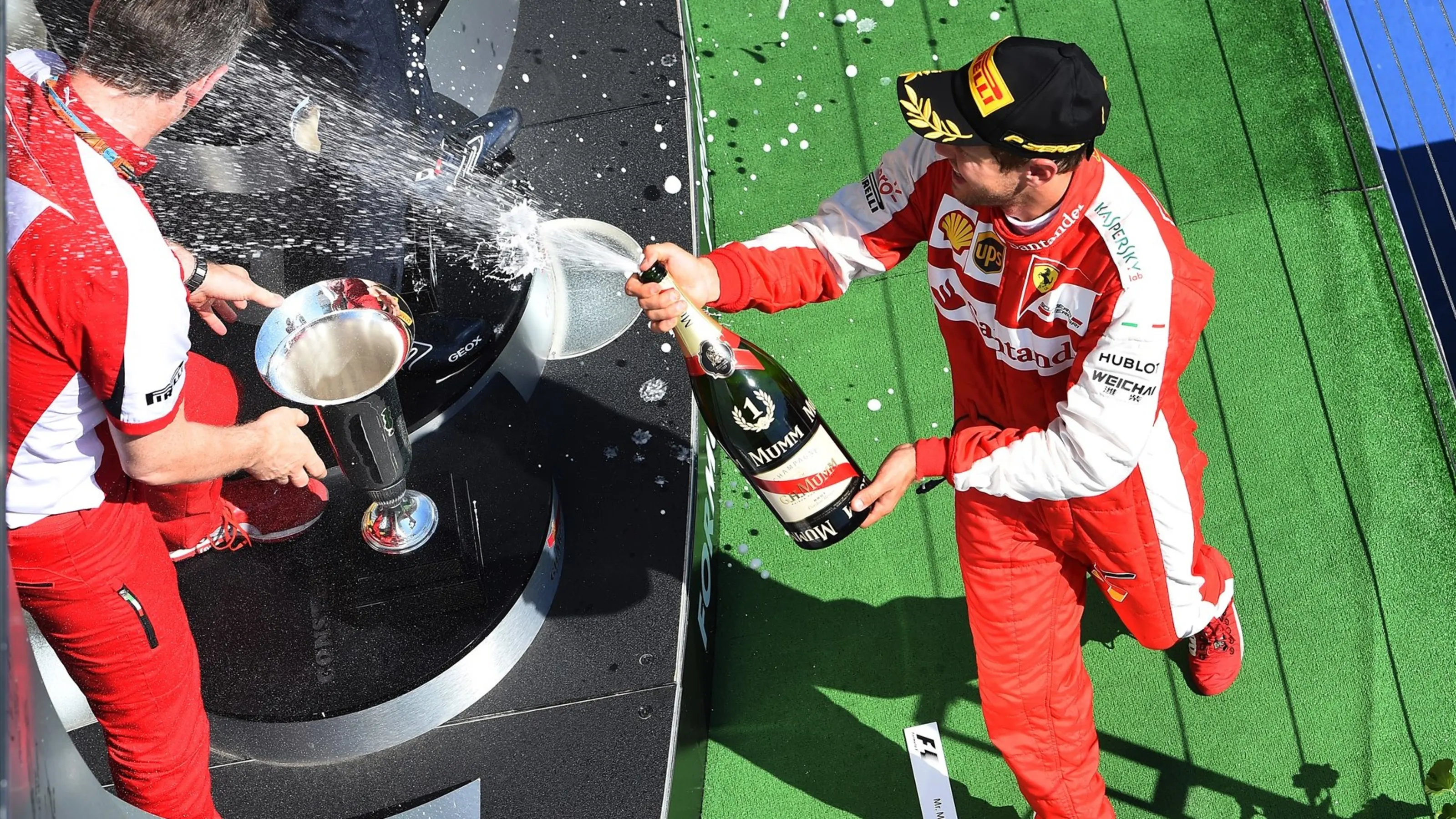 Race winner Sebastian Vettel (GER) Ferrari celebrates on the podium with the champagne at Formula