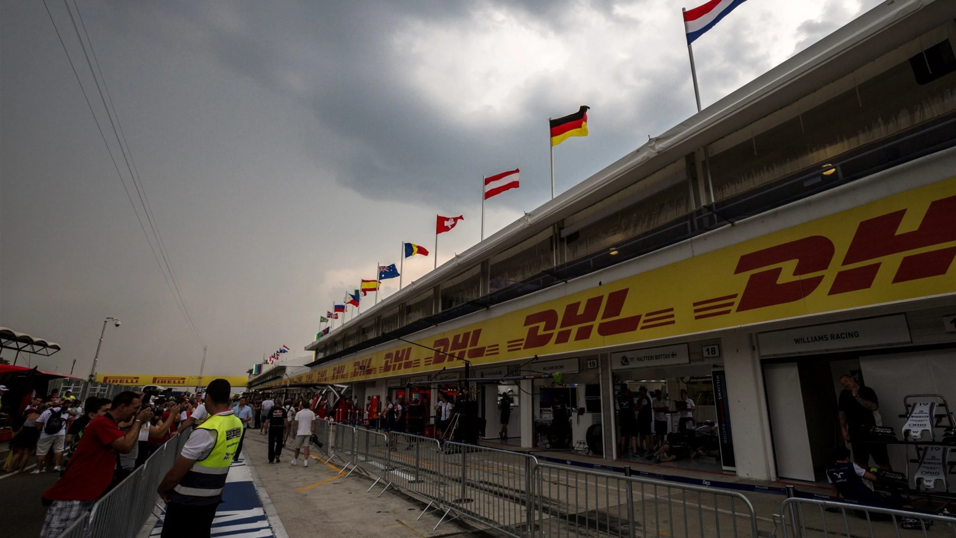Thunderstorm approaching over pit lane and DHL signage at Formula One World Championship, Rd10,