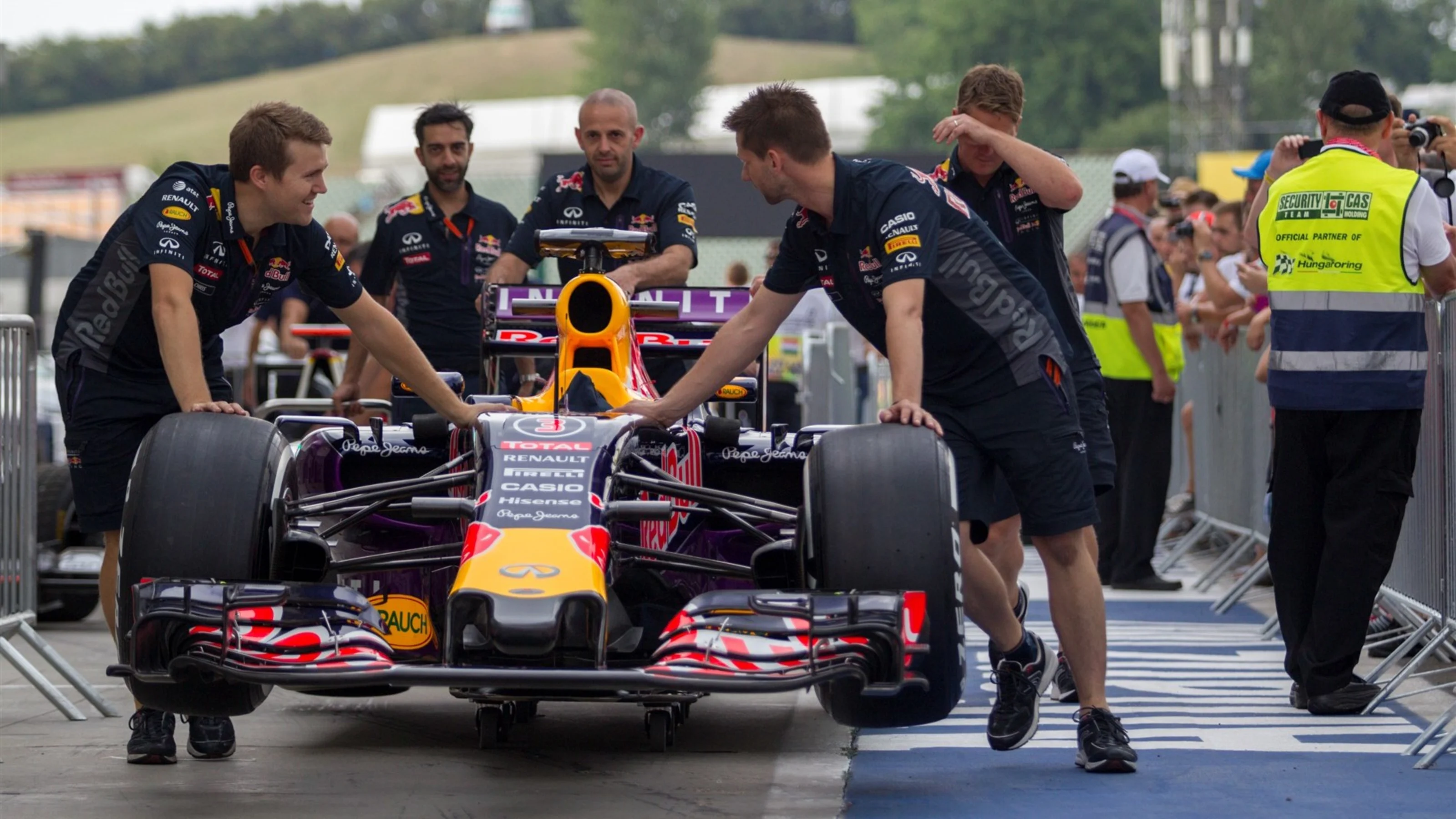 Red Bull Racing mechanics push Red Bull Racing RB11 in pit lane at Formula One World Championship,