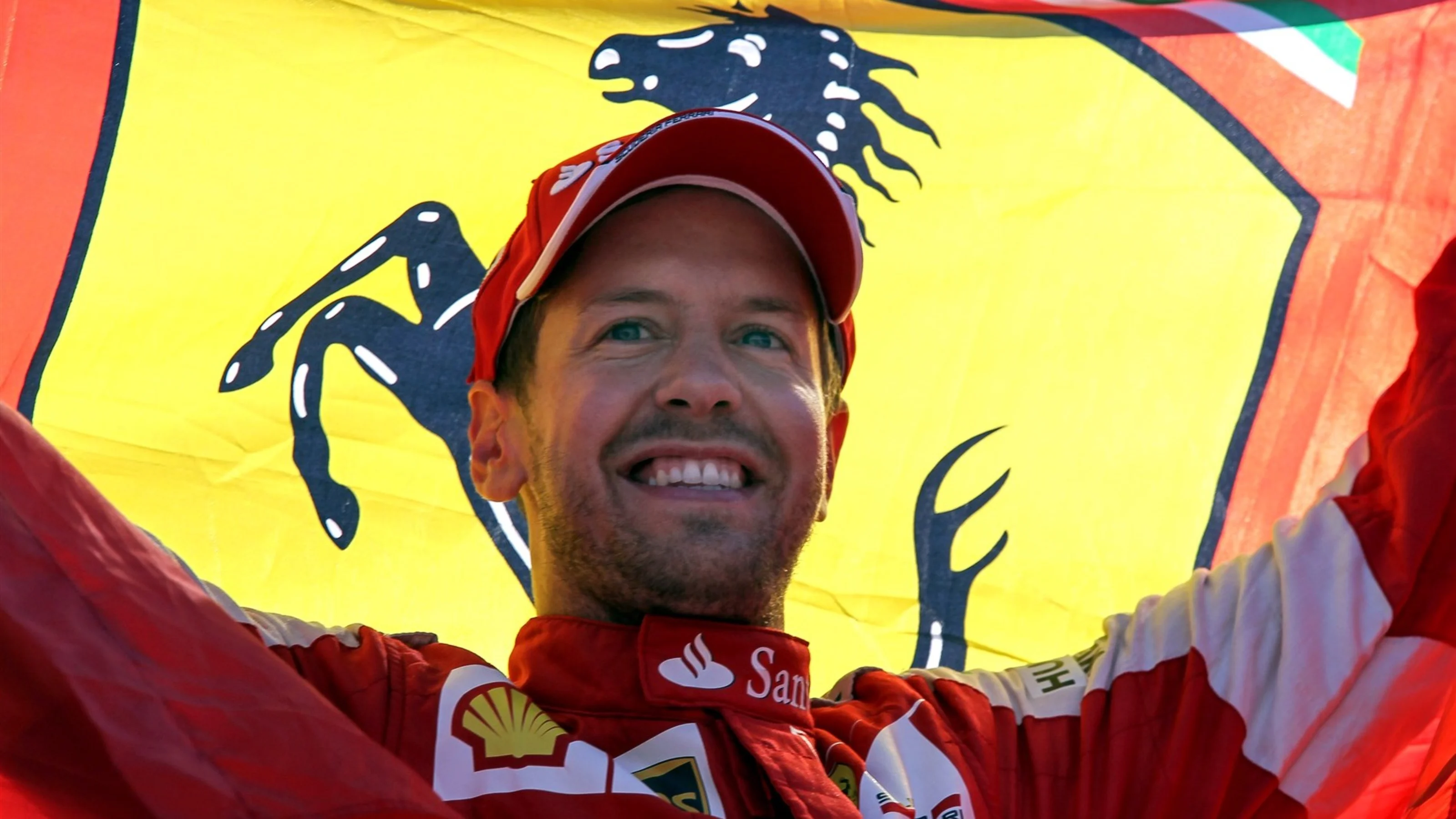 Sebastian Vettel (GER) Ferrari celebrates with the Ferrari flag on the podium at Formula One World