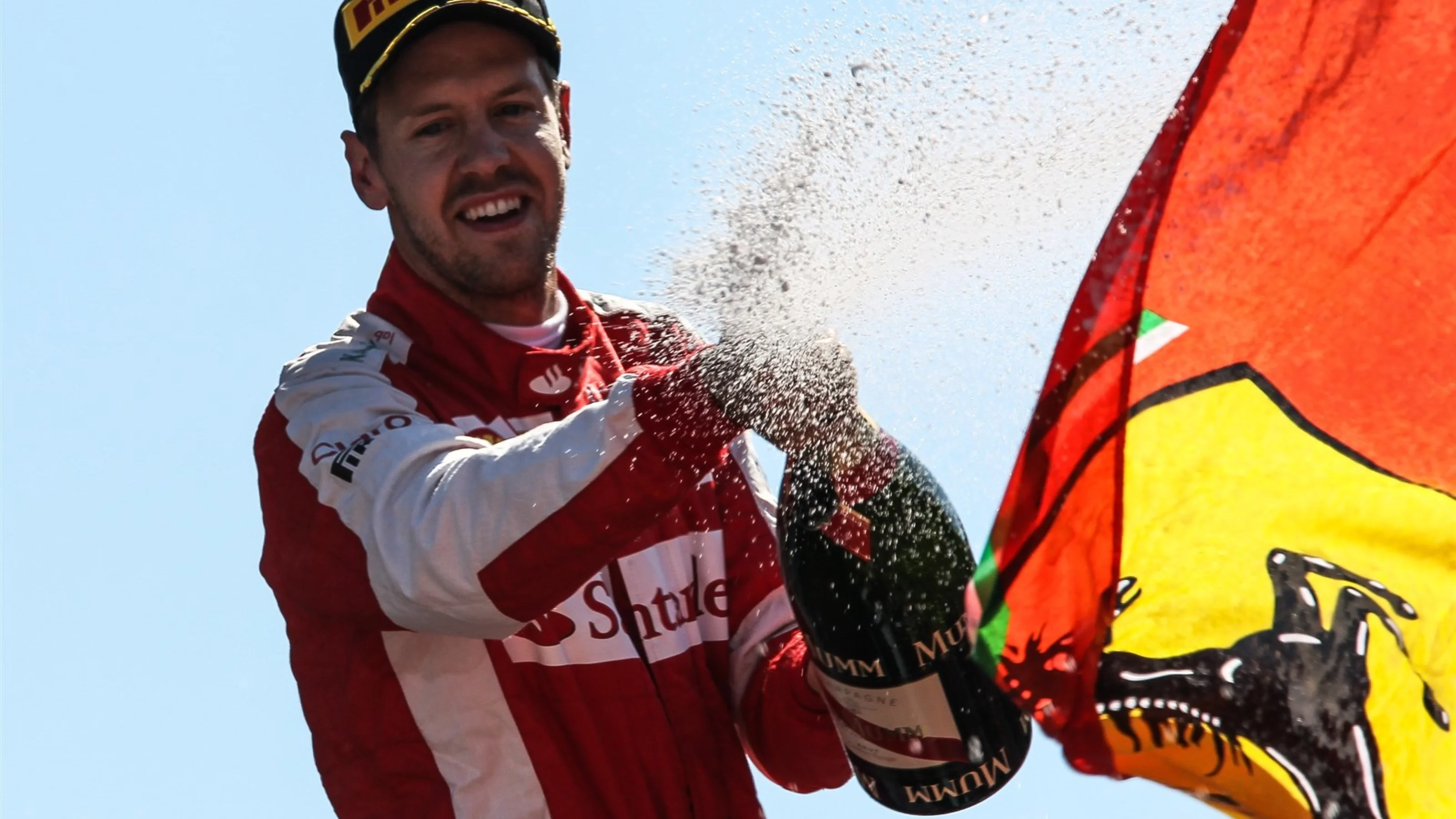 Sebastian Vettel (GER) Ferrari celebrates with champagne on the podium at Formula One World