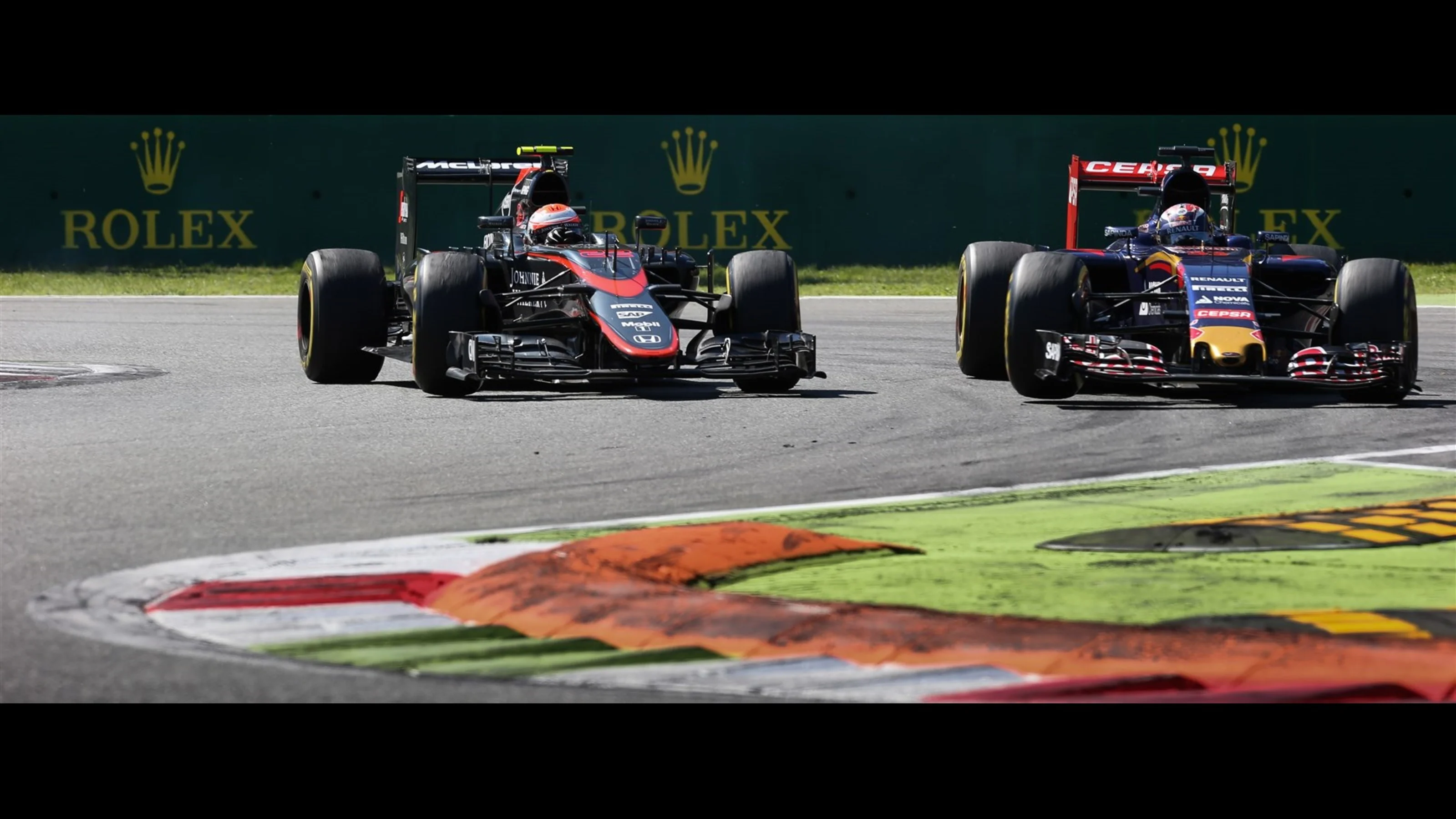Jenson Button (GBR) McLaren MP4-30 and Max Verstappen (NDL) Scuderia Toro Rosso STR10 at Formula