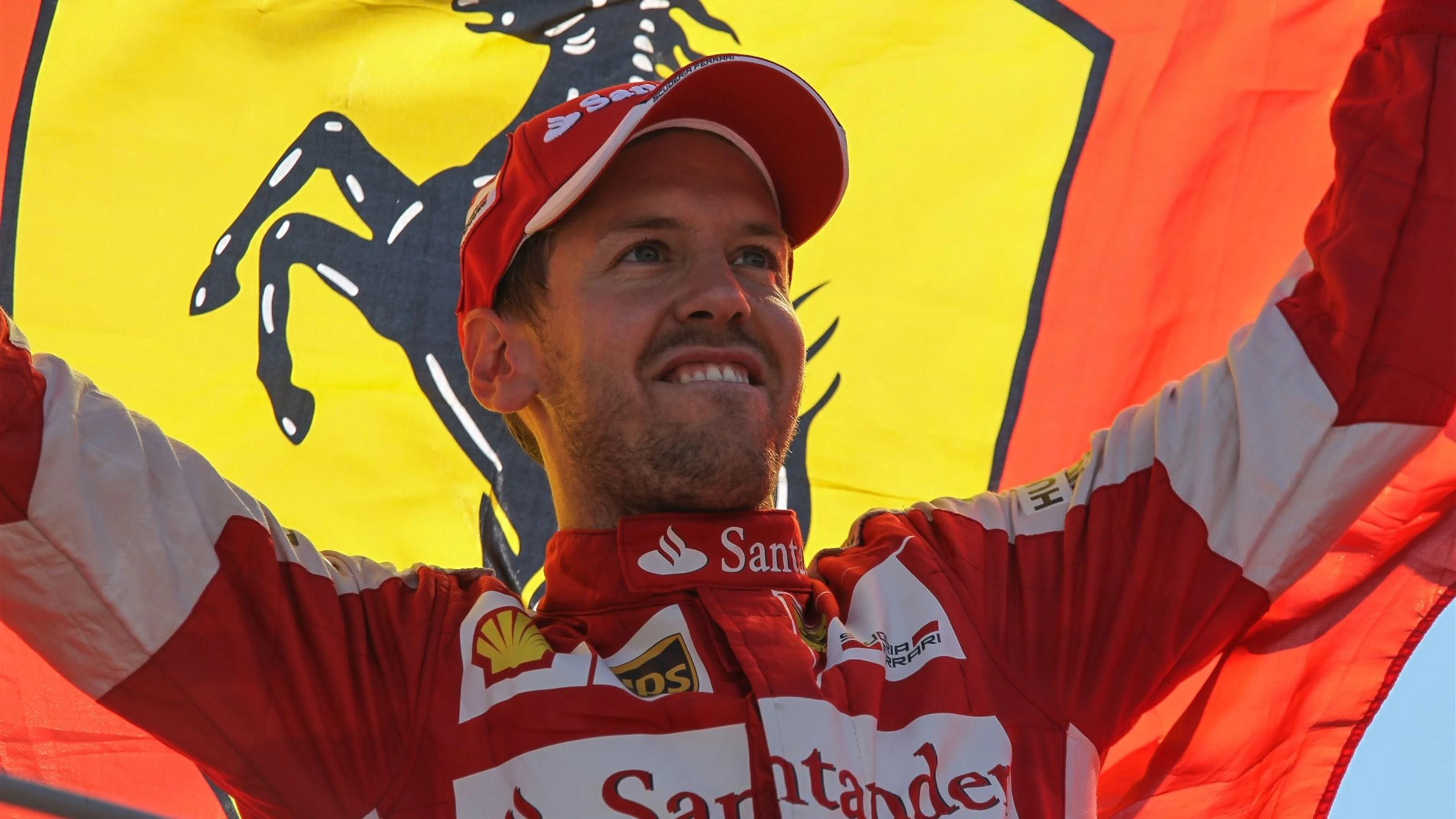 Sebastian Vettel (GER) Ferrari celebrates with the Ferrari flag on the podium at Formula One World