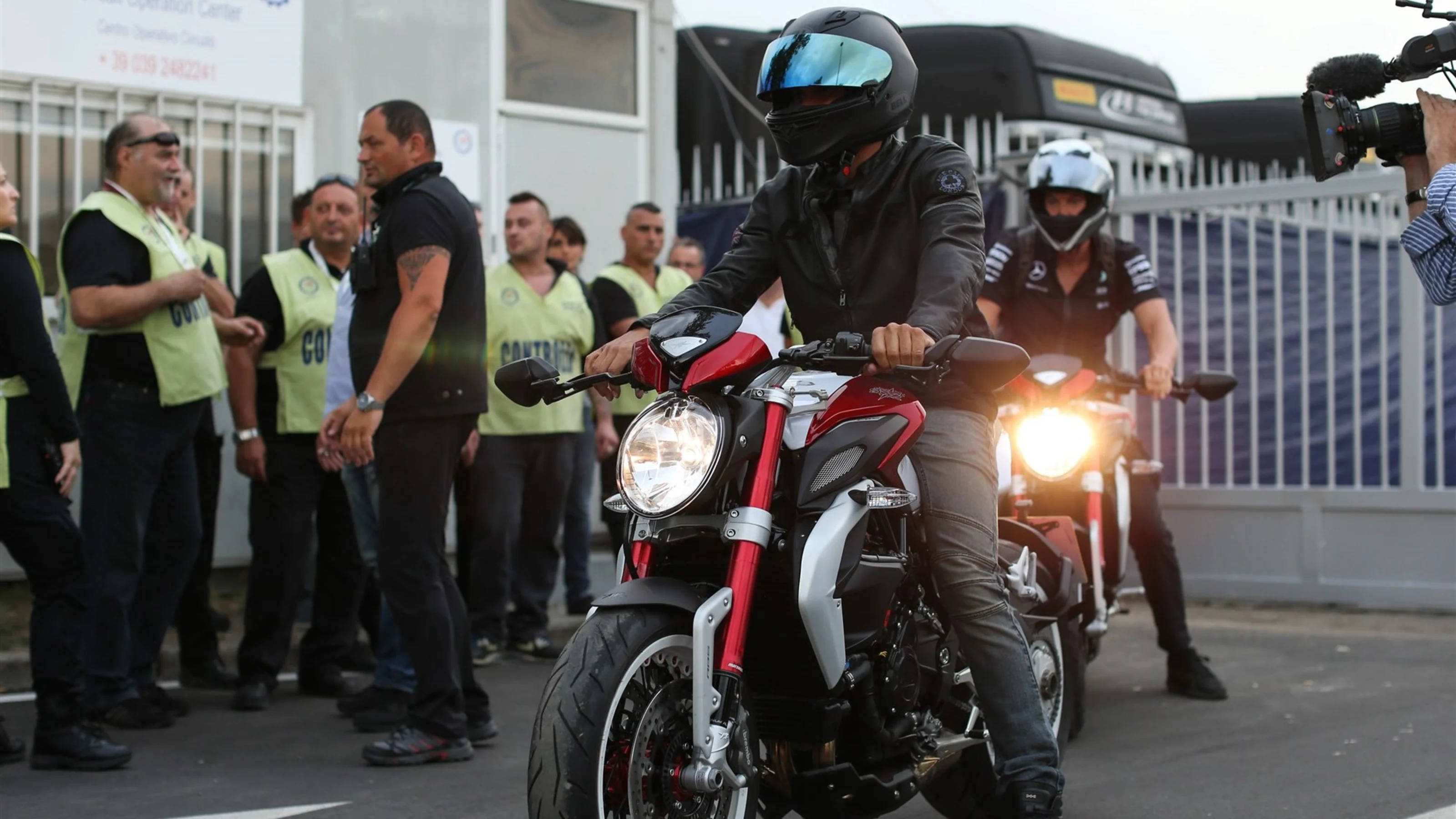 Lewis Hamilton (GBR) Mercedes AMG F1 arrives on a motorcycle at Formula One World Championship,