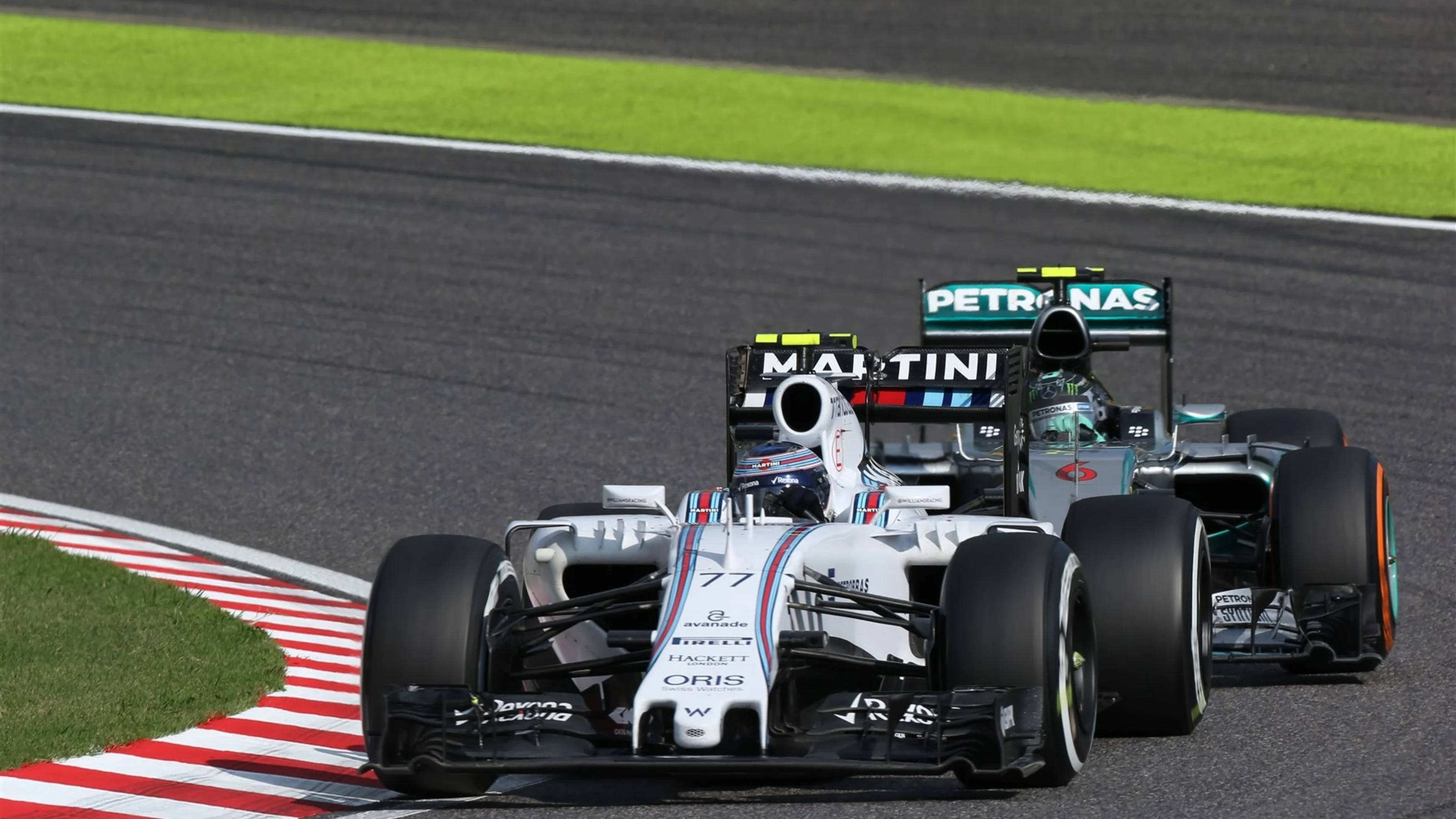 Valtteri Bottas (FIN) Williams FW37 and Nico Rosberg (GER) Mercedes AMG F1 W06 battle for position