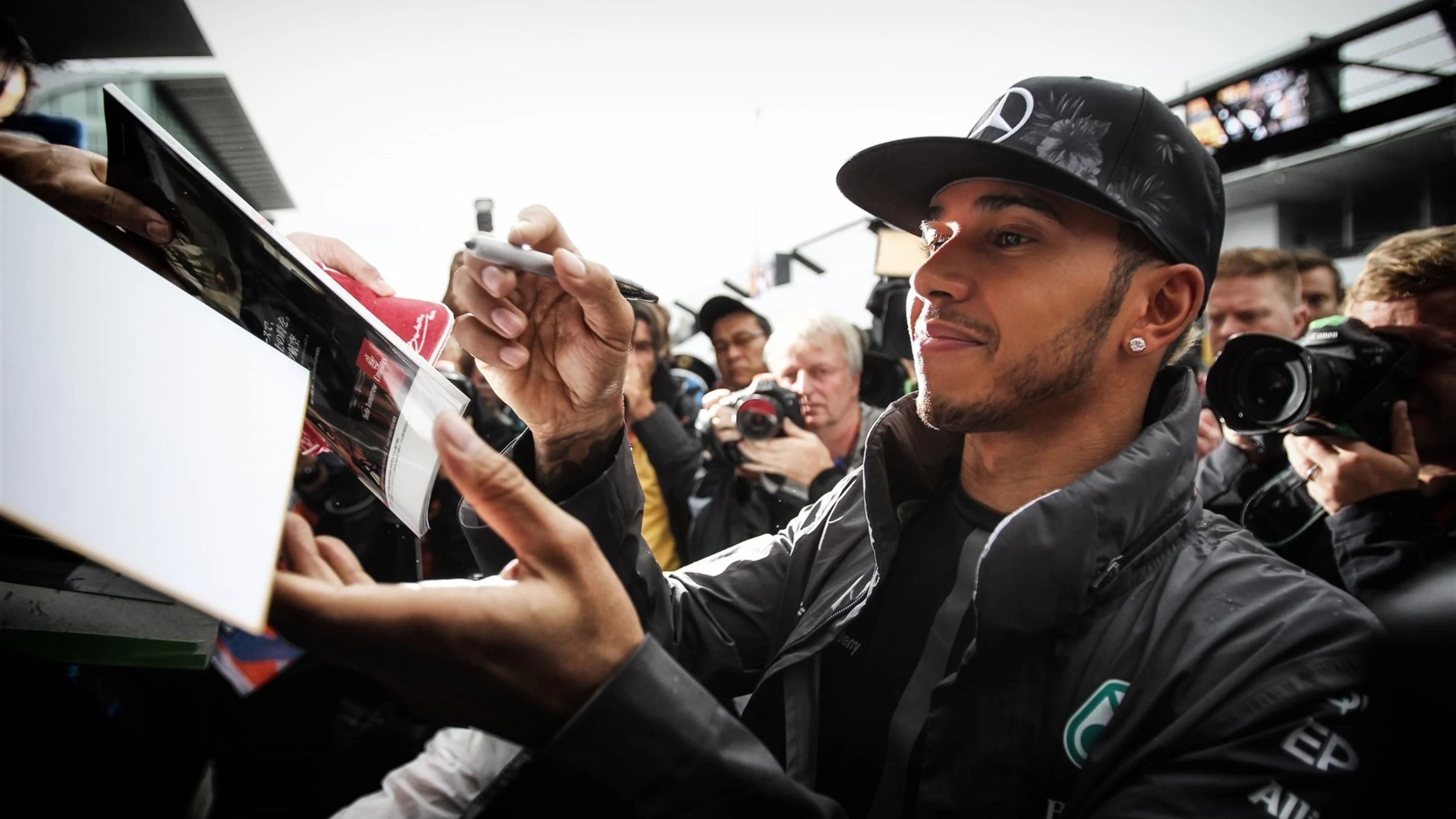 Lewis Hamilton (GBR) Mercedes AMG F1 signs autographs for the fans at Formula One World