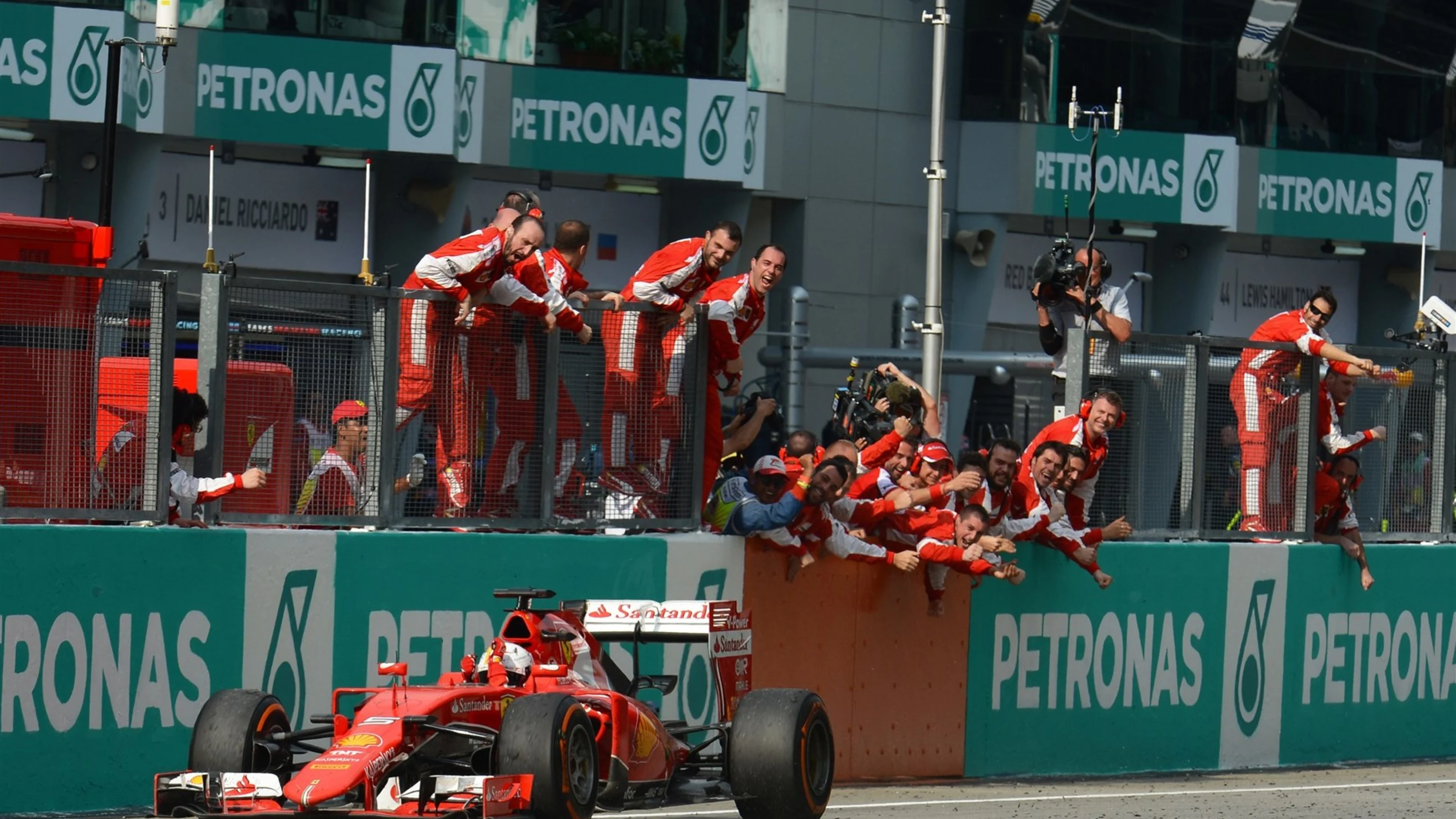 Race winner Sebastian Vettel (GER) Ferrari SF15-T crosses the line at Formula One World