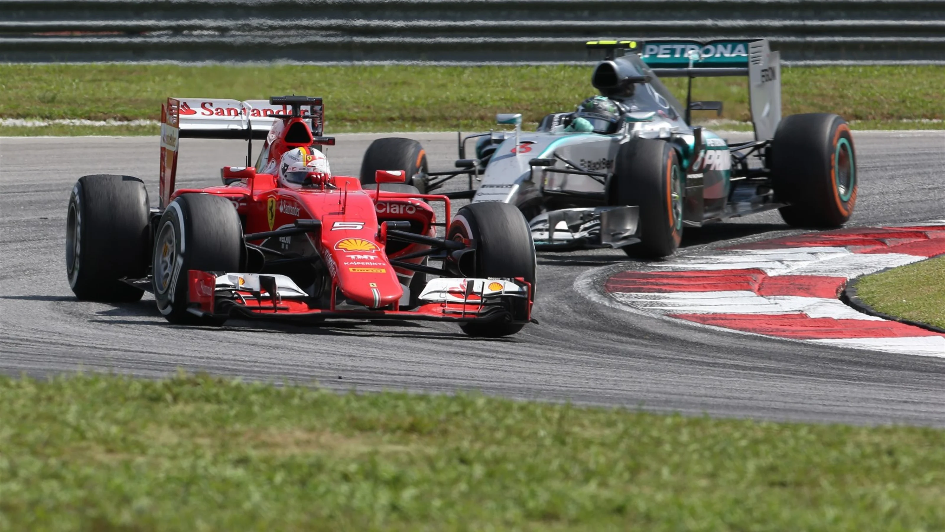 Sebastian Vettel (GER) Ferrari SF15-T leads Nico Rosberg (GER) Mercedes AMG F1 W06 at Formula One