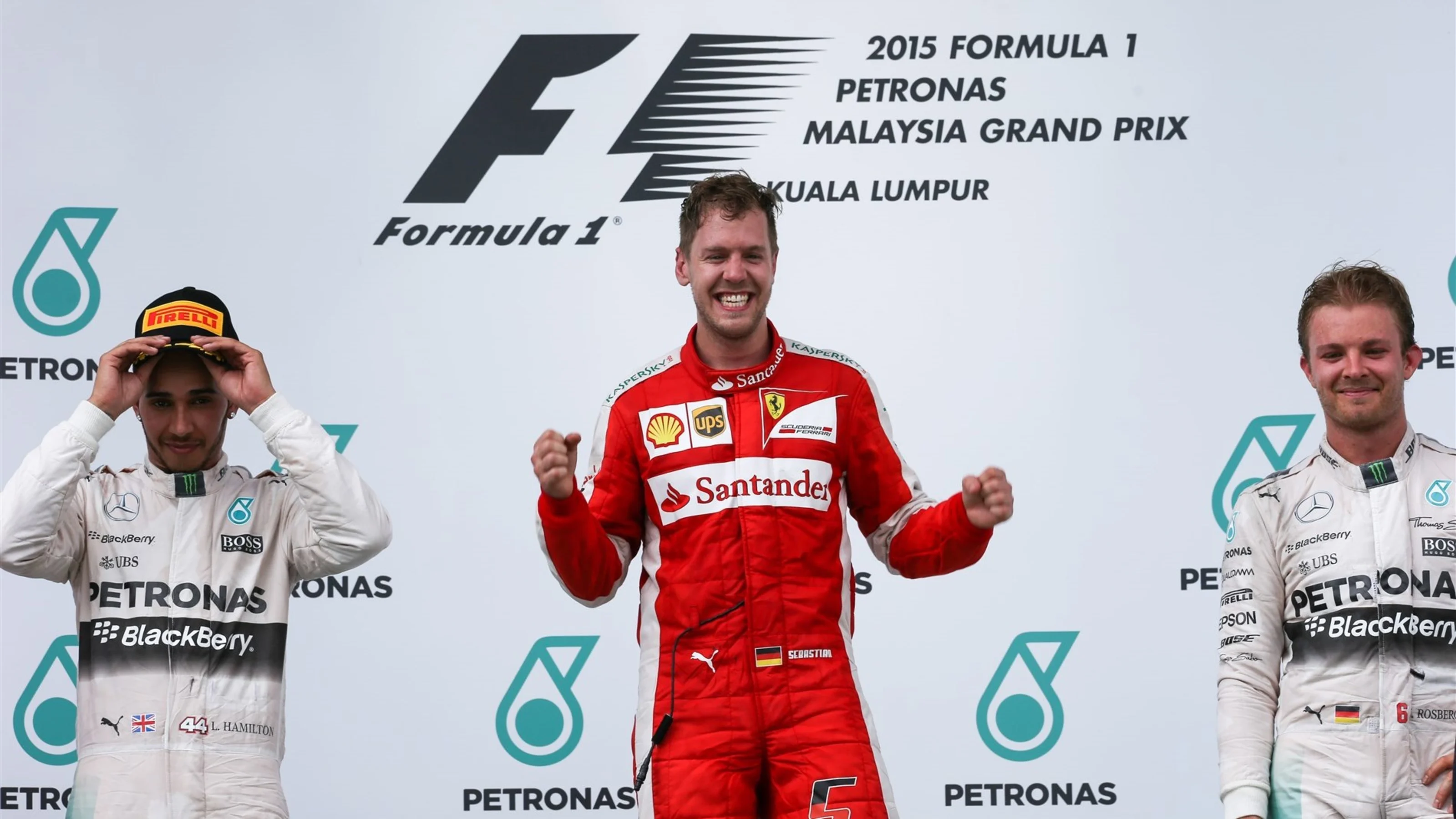 Race winner Sebastian Vettel (GER) Ferrari celebrates on the podium with Lewis Hamilton (GBR)