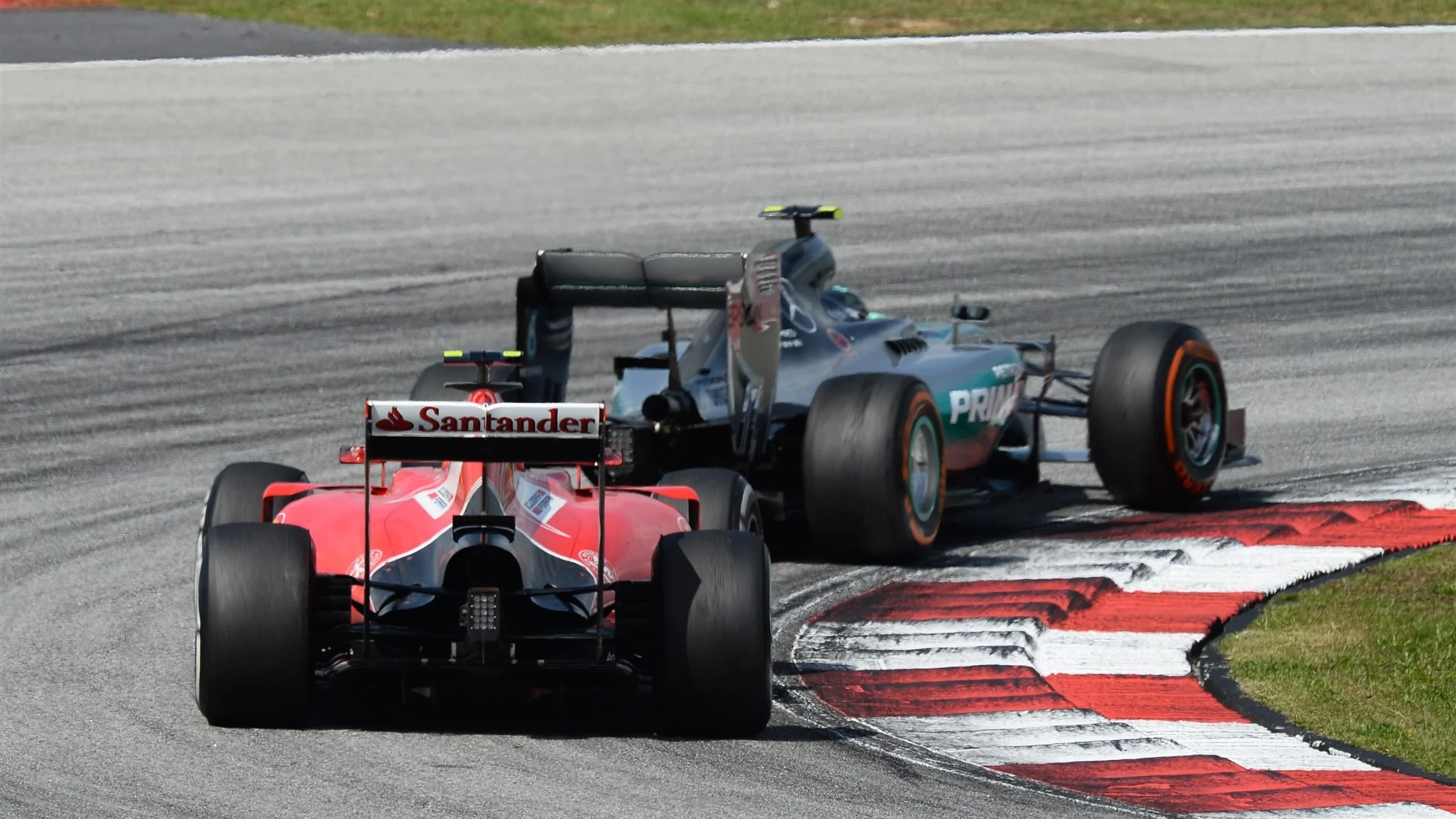 Kimi Raikkonen (FIN) Ferrari SF15-T follows Nico Rosberg (GER) Mercedes AMG F1 W06 at Formula One