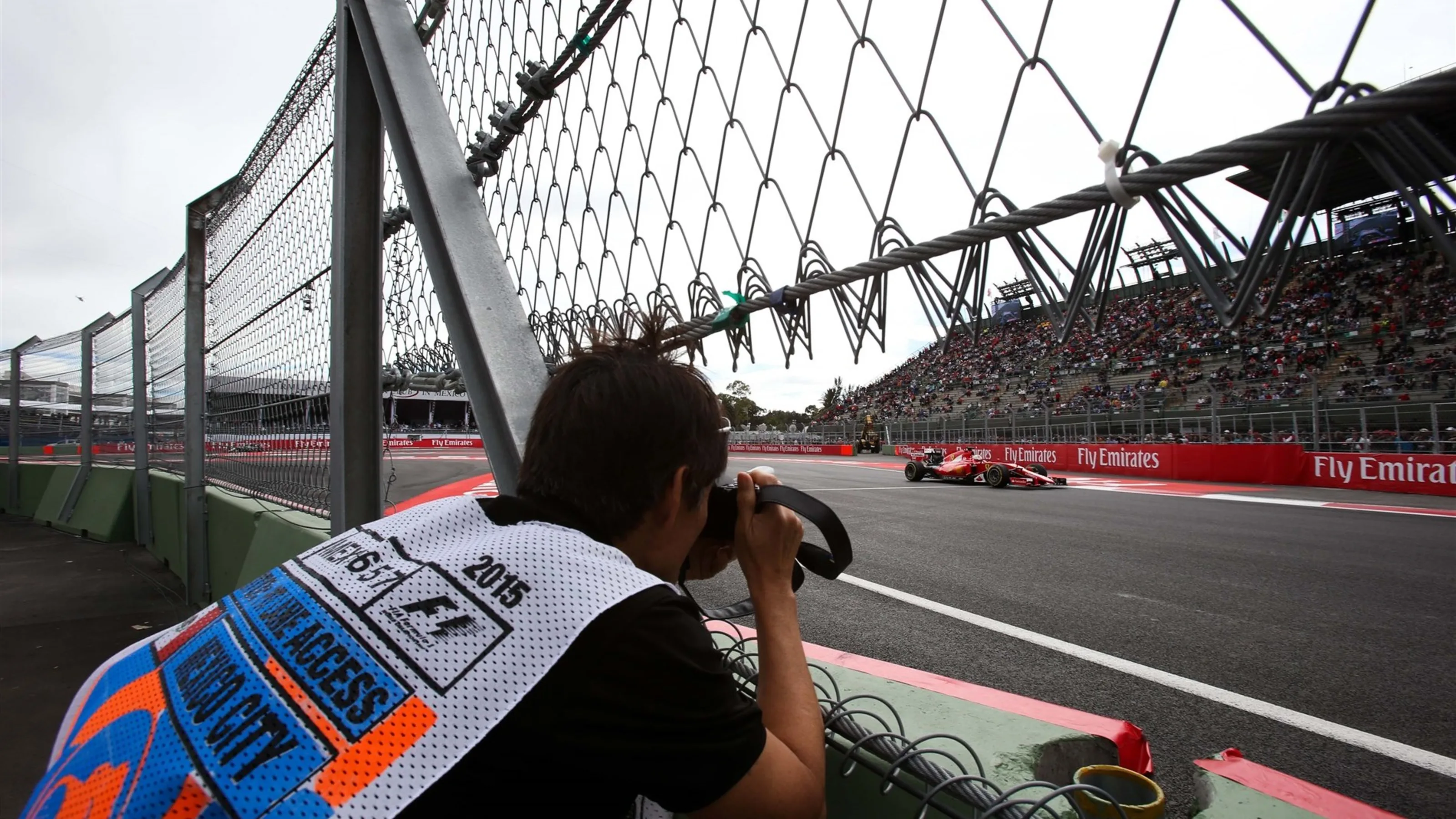 Sebastian Vettel (GER) Ferrari SF15-T and photographer at Formula One World Championship, Rd17,