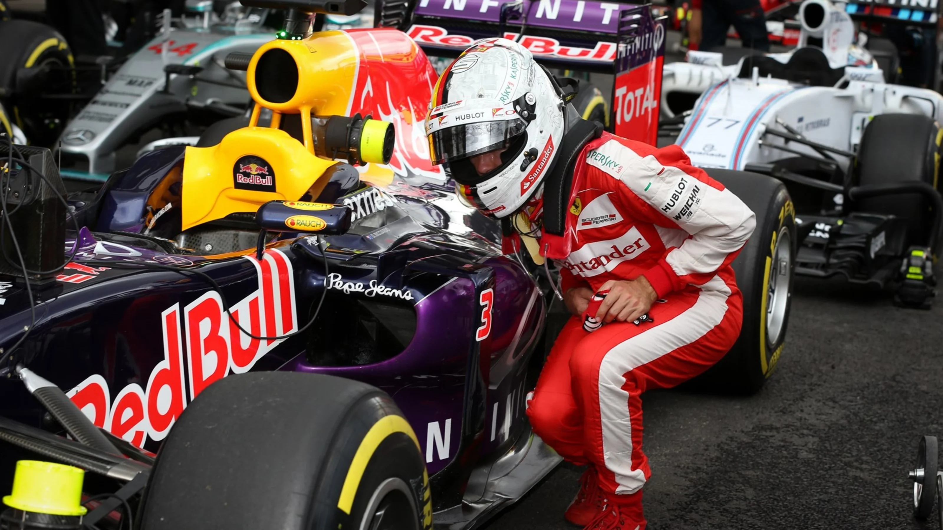 Sebastian Vettel (GER) Ferrari looks at the Red Bull Racing RB11 car at Formula One World