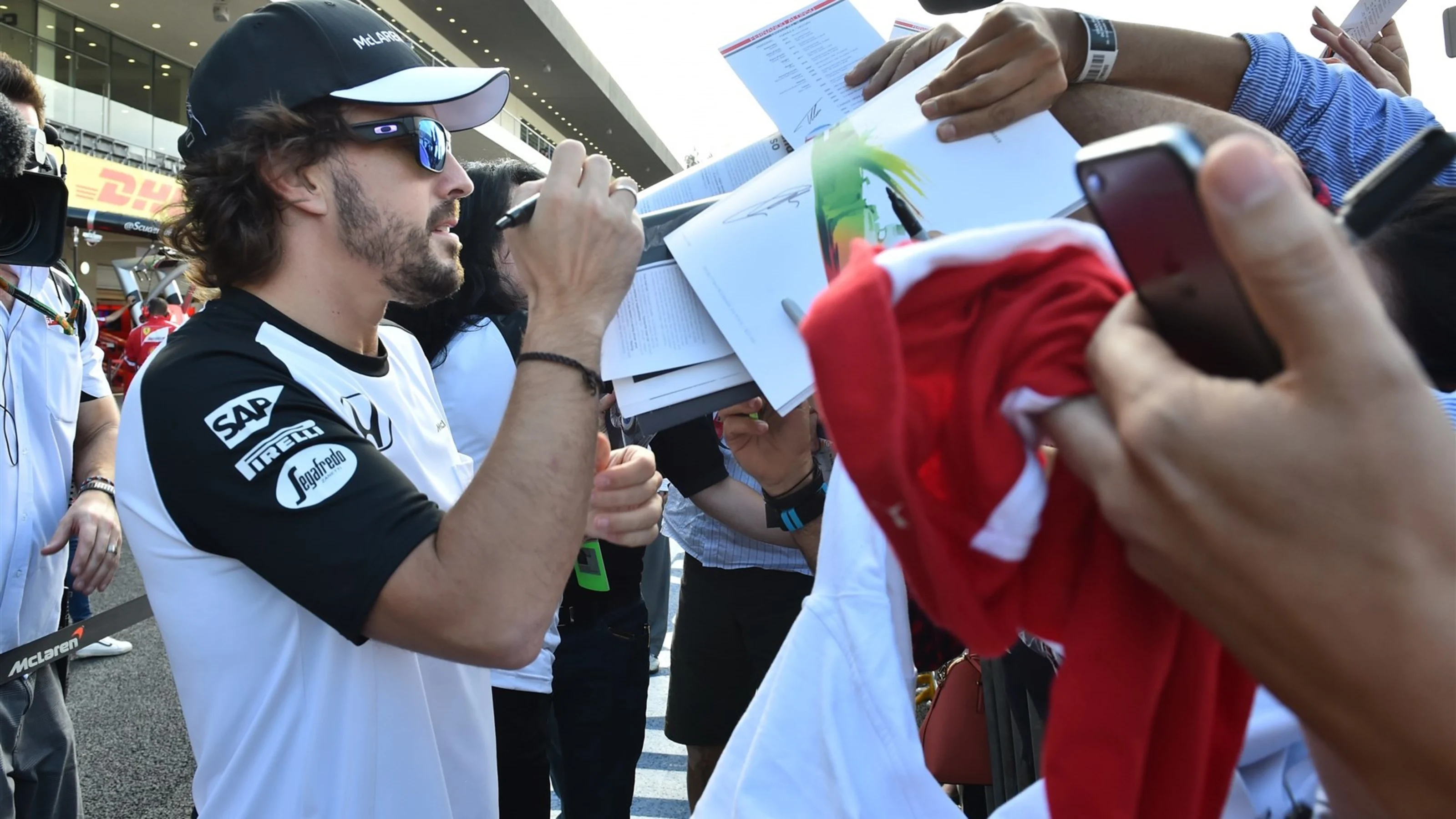 Fernando Alonso (ESP) McLaren with fans at the autograph session at Formula One World Championship,