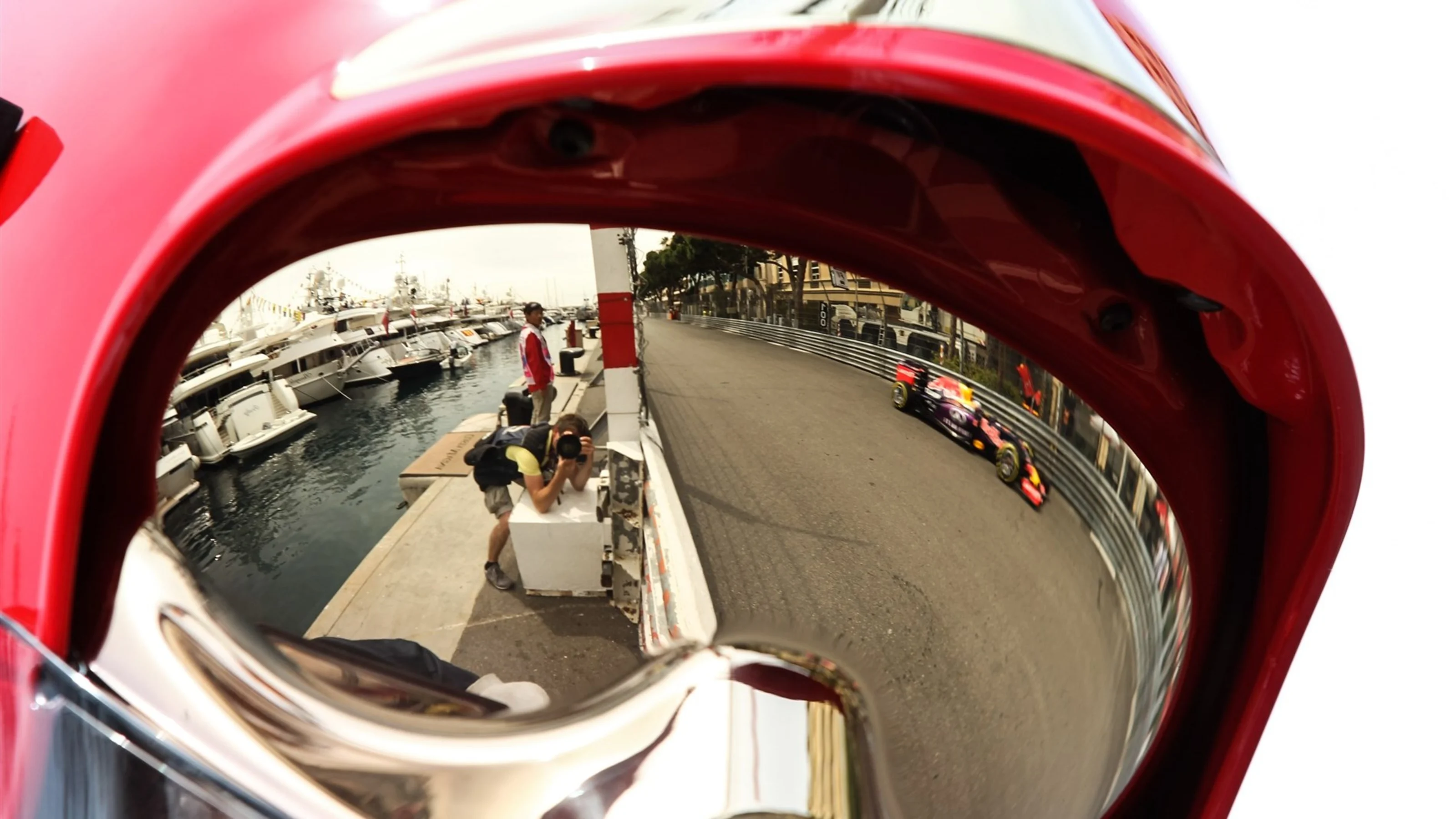 Daniel Ricciardo (AUS) Red Bull Racing RB11 reflected in a firemans helmet at Formula One World
