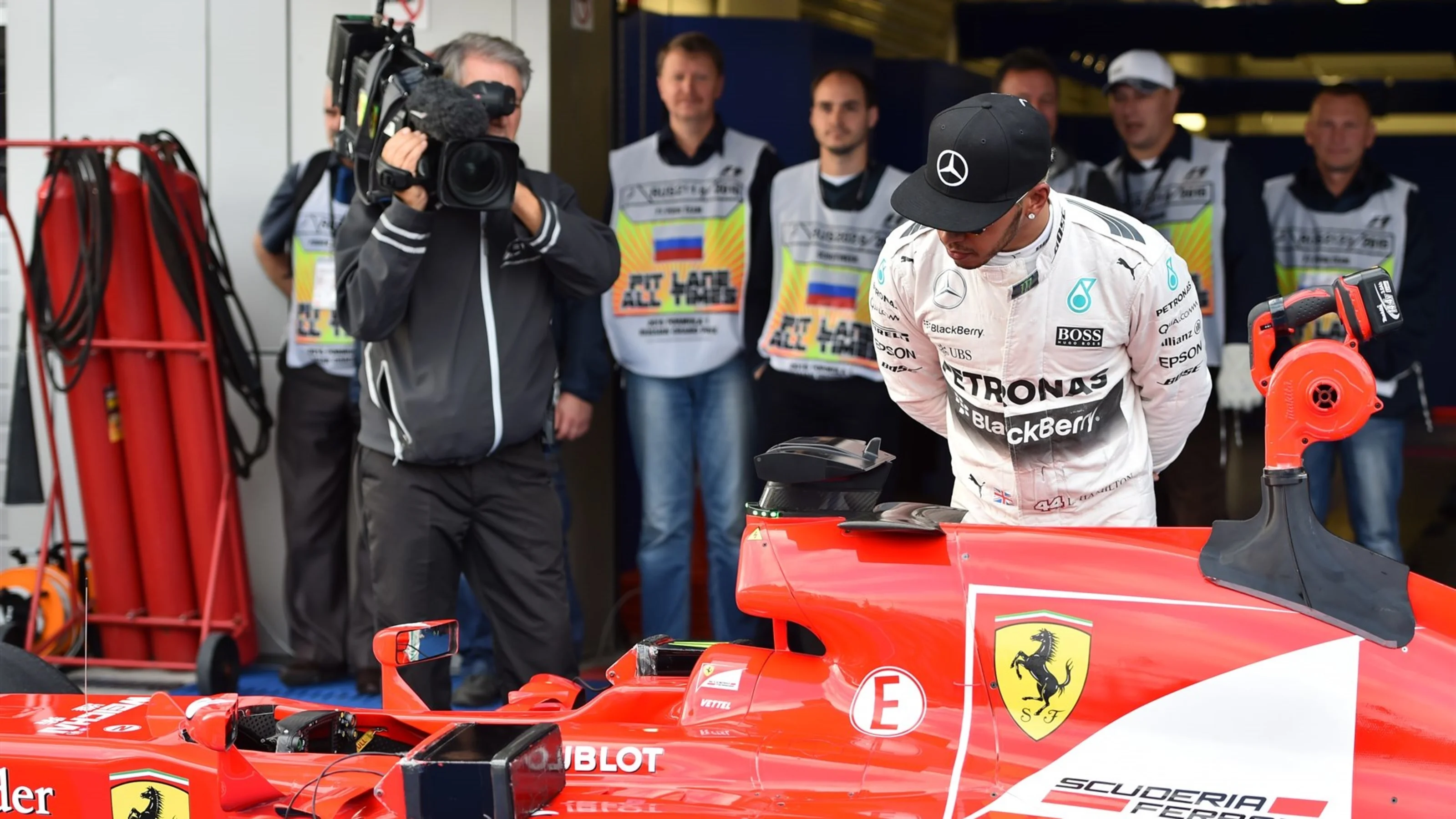 Lewis Hamilton (GBR) Mercedes AMG F1 W06 looks at the car of Sebastian Vettel (GER) Ferrari SF15-T