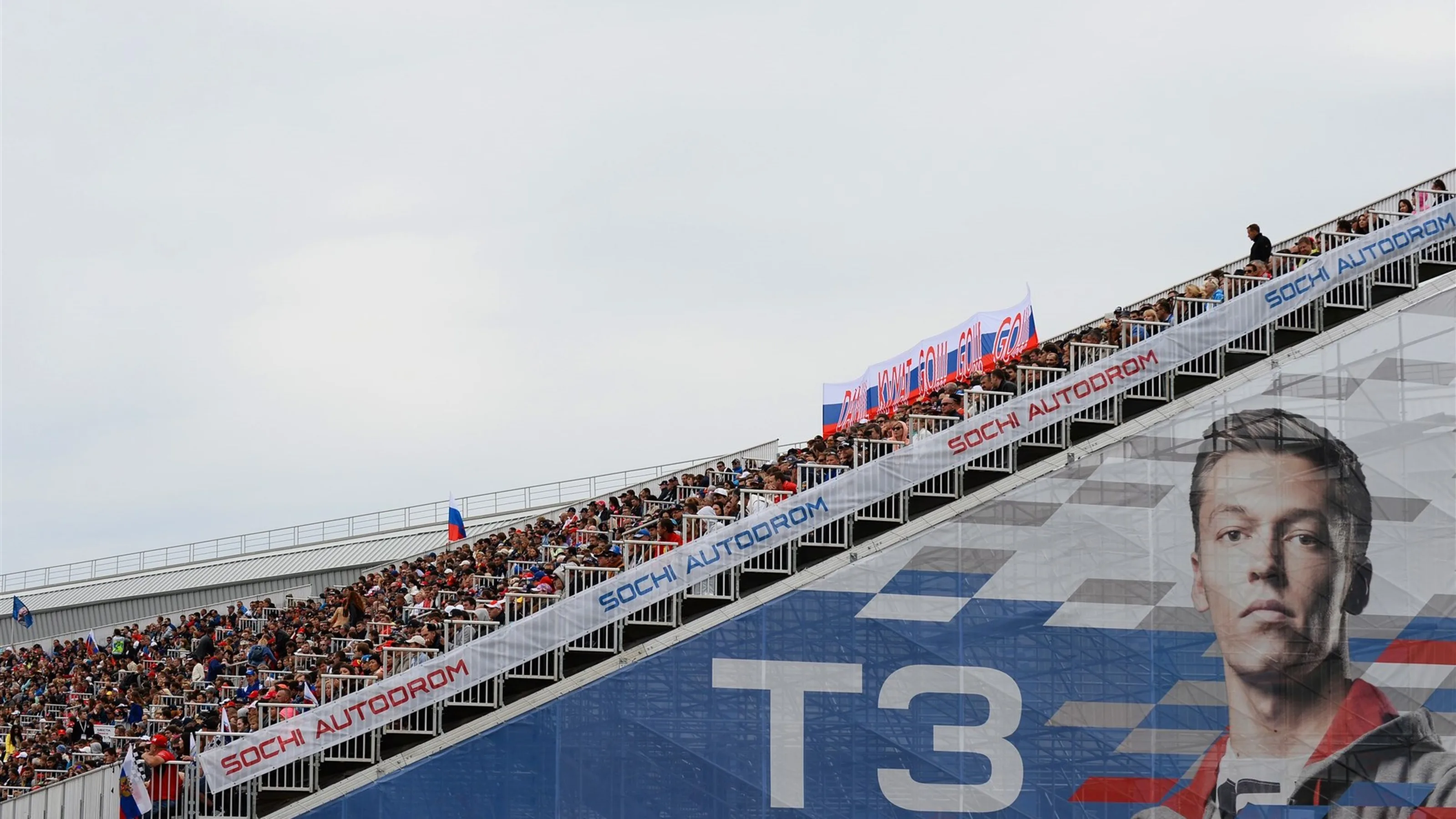Fans and Daniil Kyvat (RUS) Red Bull Racing signage on the grandstand at Formula One World
