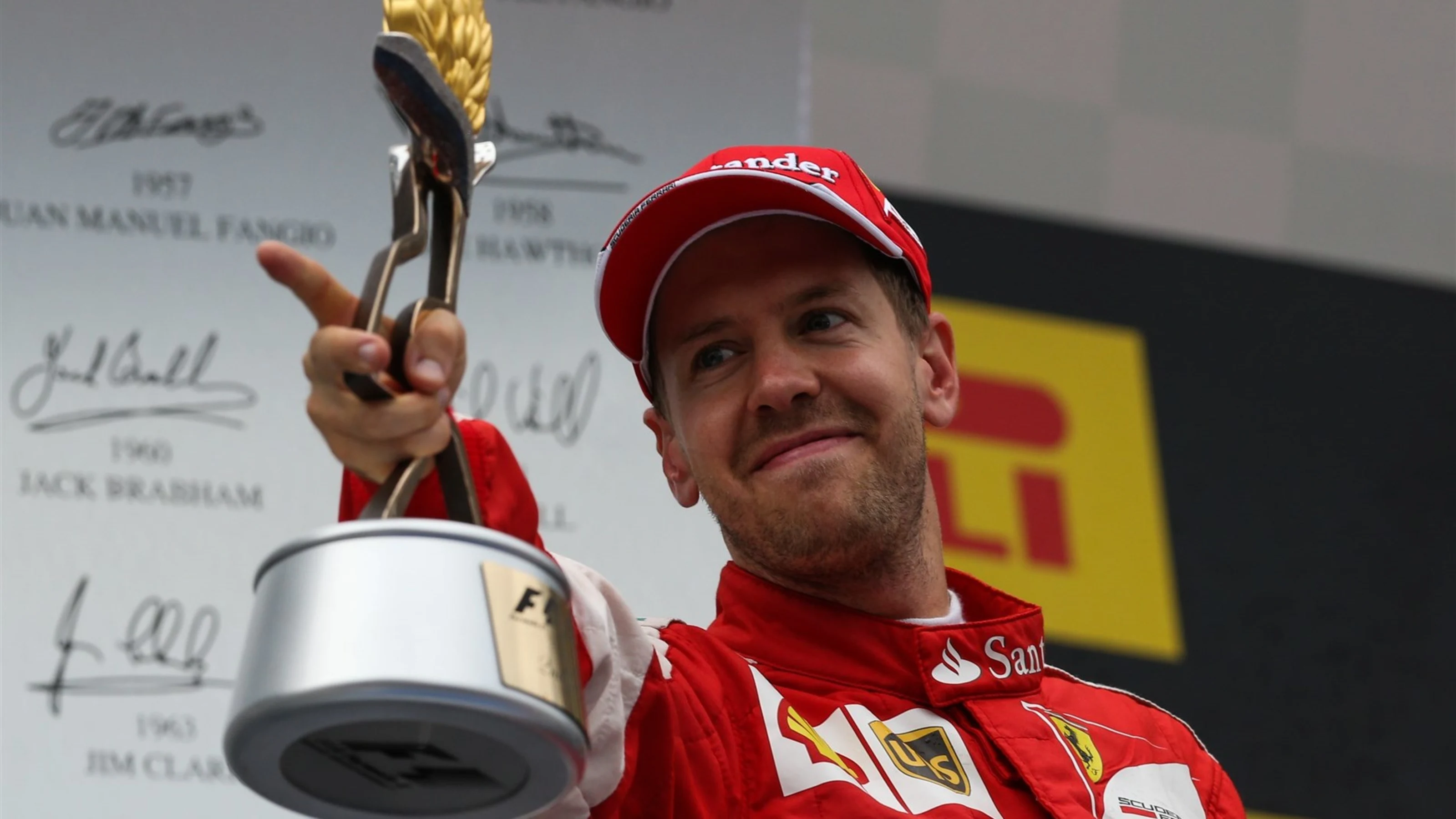 Sebastian Vettel (GER) Ferrari celebrates with the trophy on the podium at Formula One World