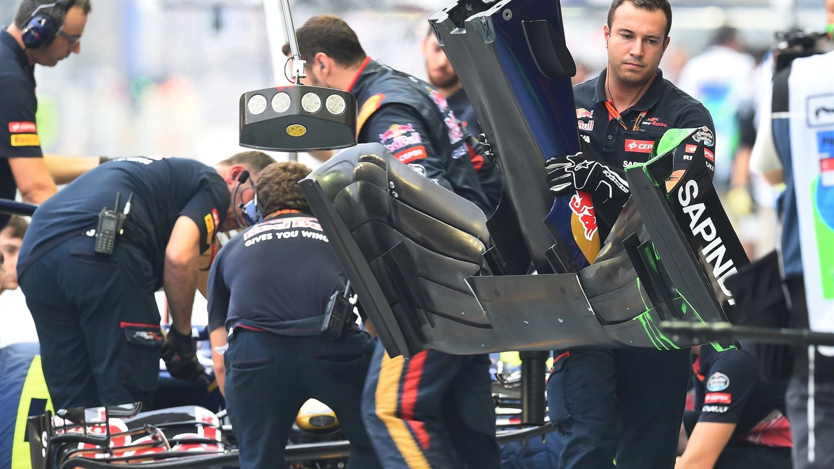Scuderia Toro Rosso mechanic with Scuderia Toro Rosso STR10 front wing at Formula One World