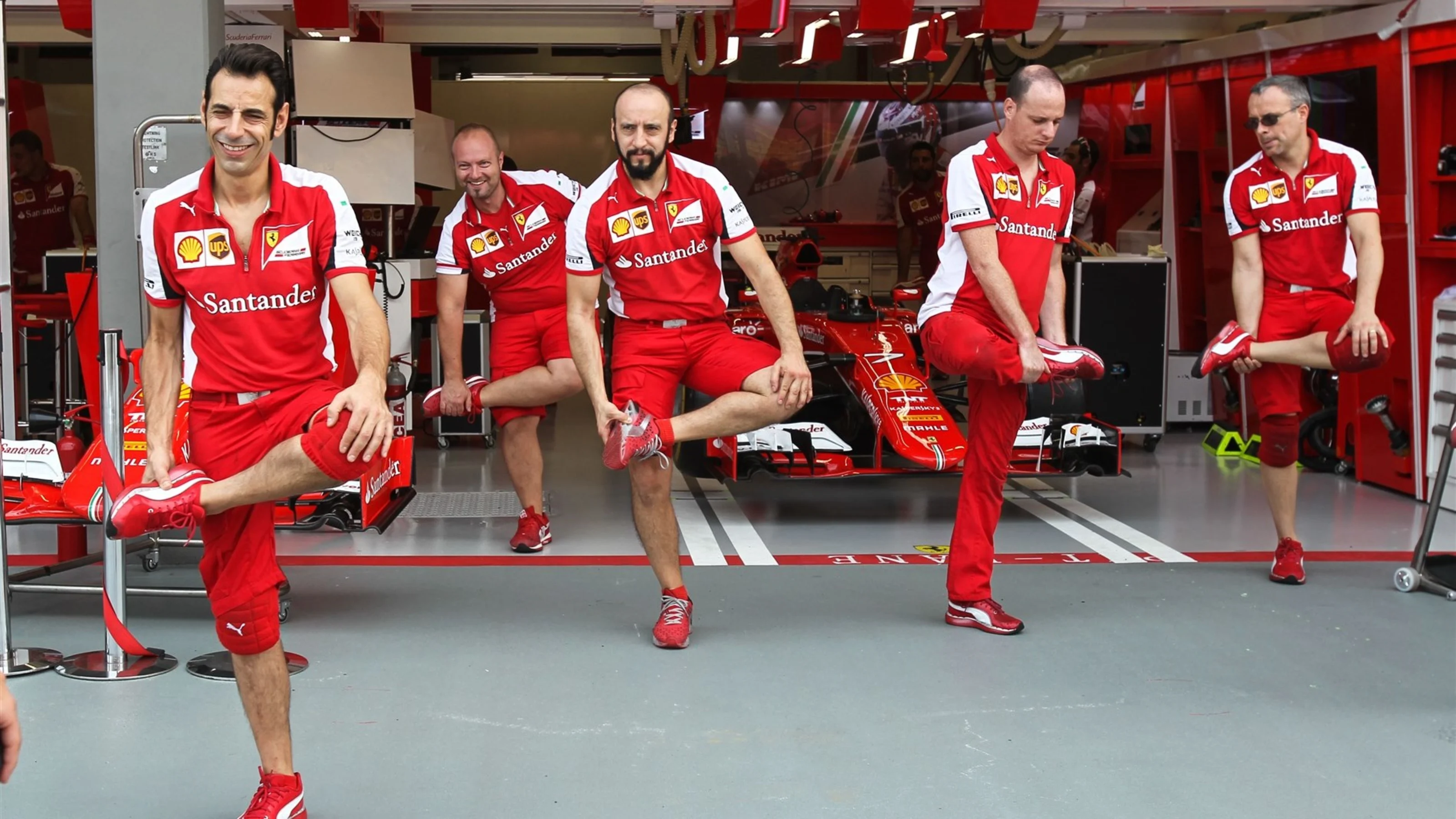 Ferrari mechanics warm up for their pit stop practice at Formula One World Championship, Rd13,
