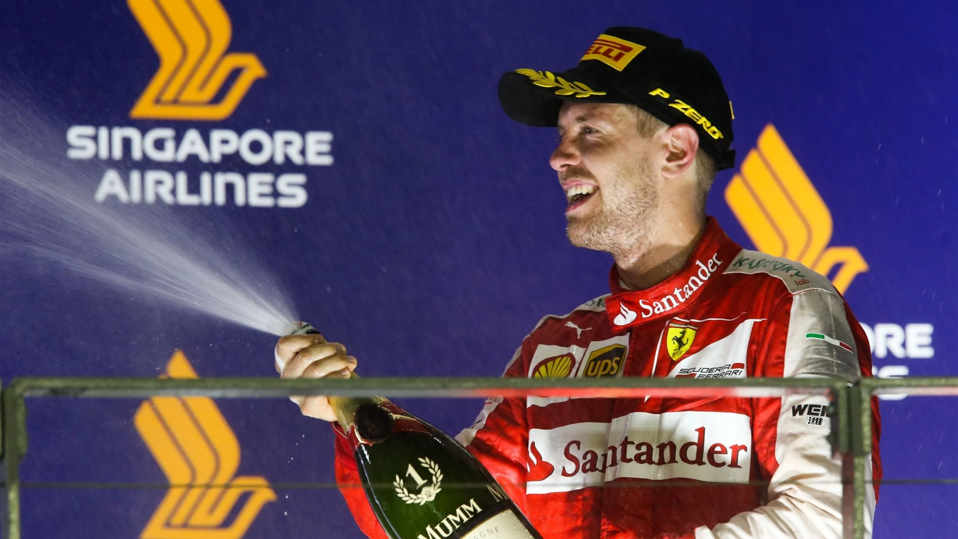 Race winner Sebastian Vettel (GER) Ferrari celebrates on the podium with champagne at Formula One