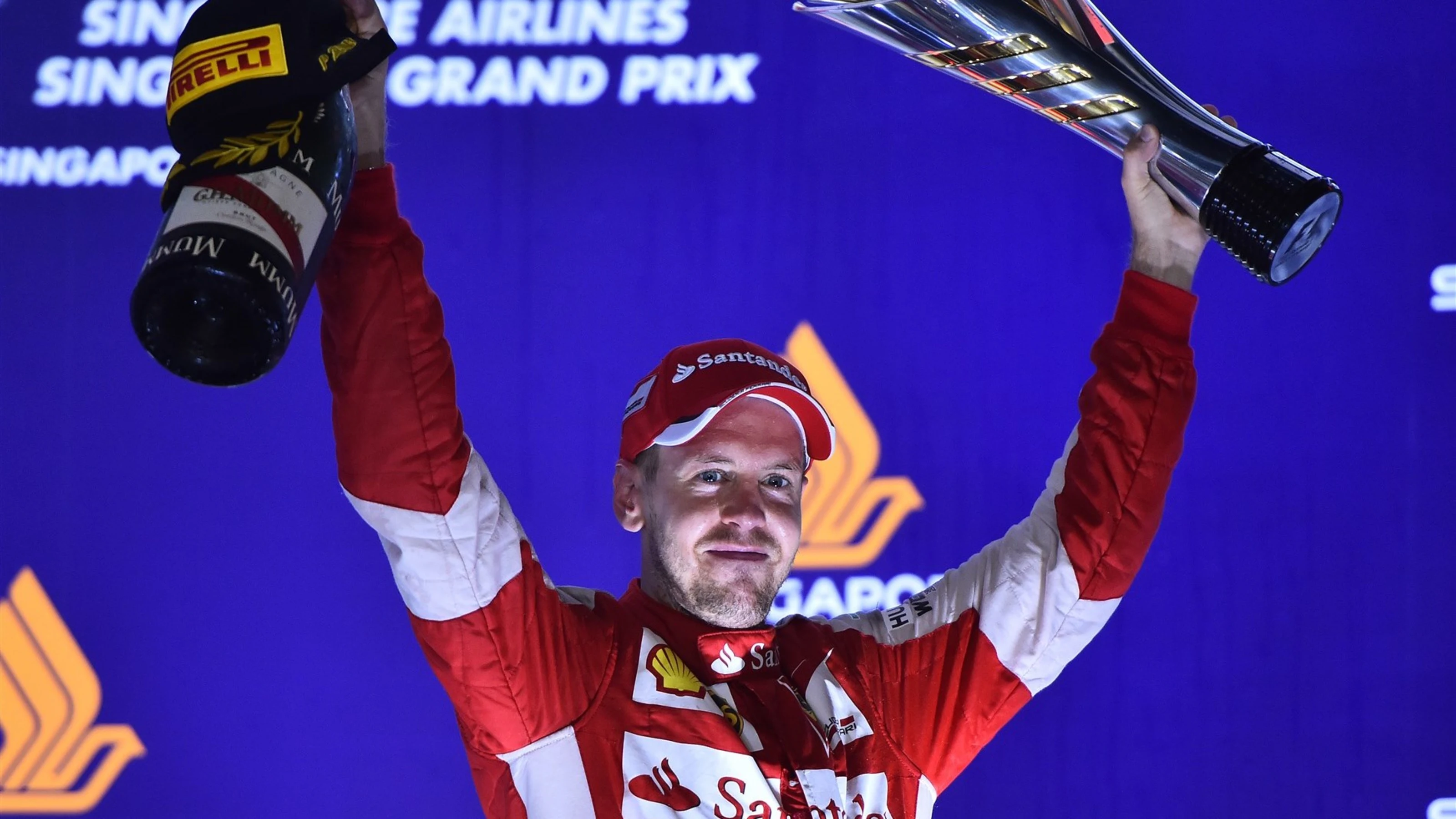 Race winner Sebastian Vettel (GER) Ferrari celebrates on the podium with the trophy at Formula One