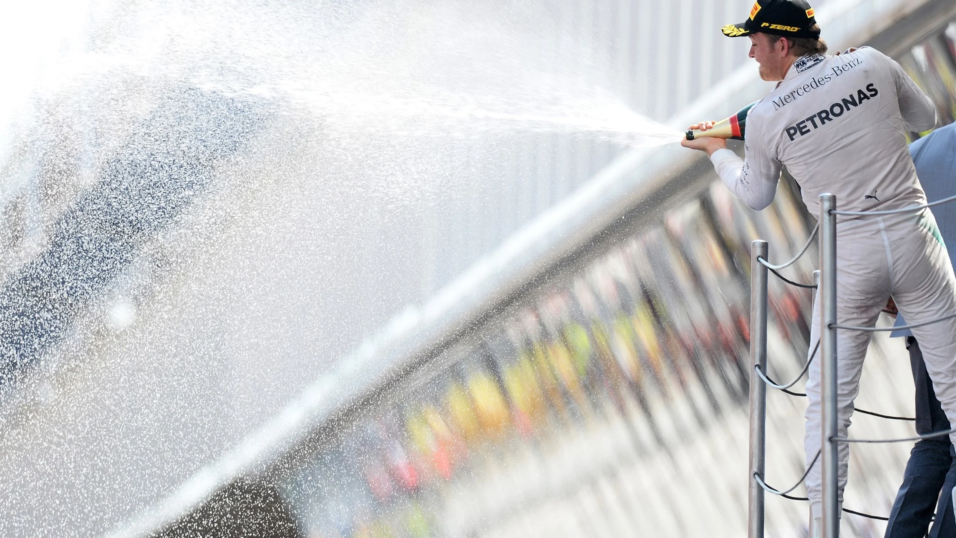 Race winner Nico Rosberg (GER) Mercedes AMG F1 celebrates with the champagne on the podium at