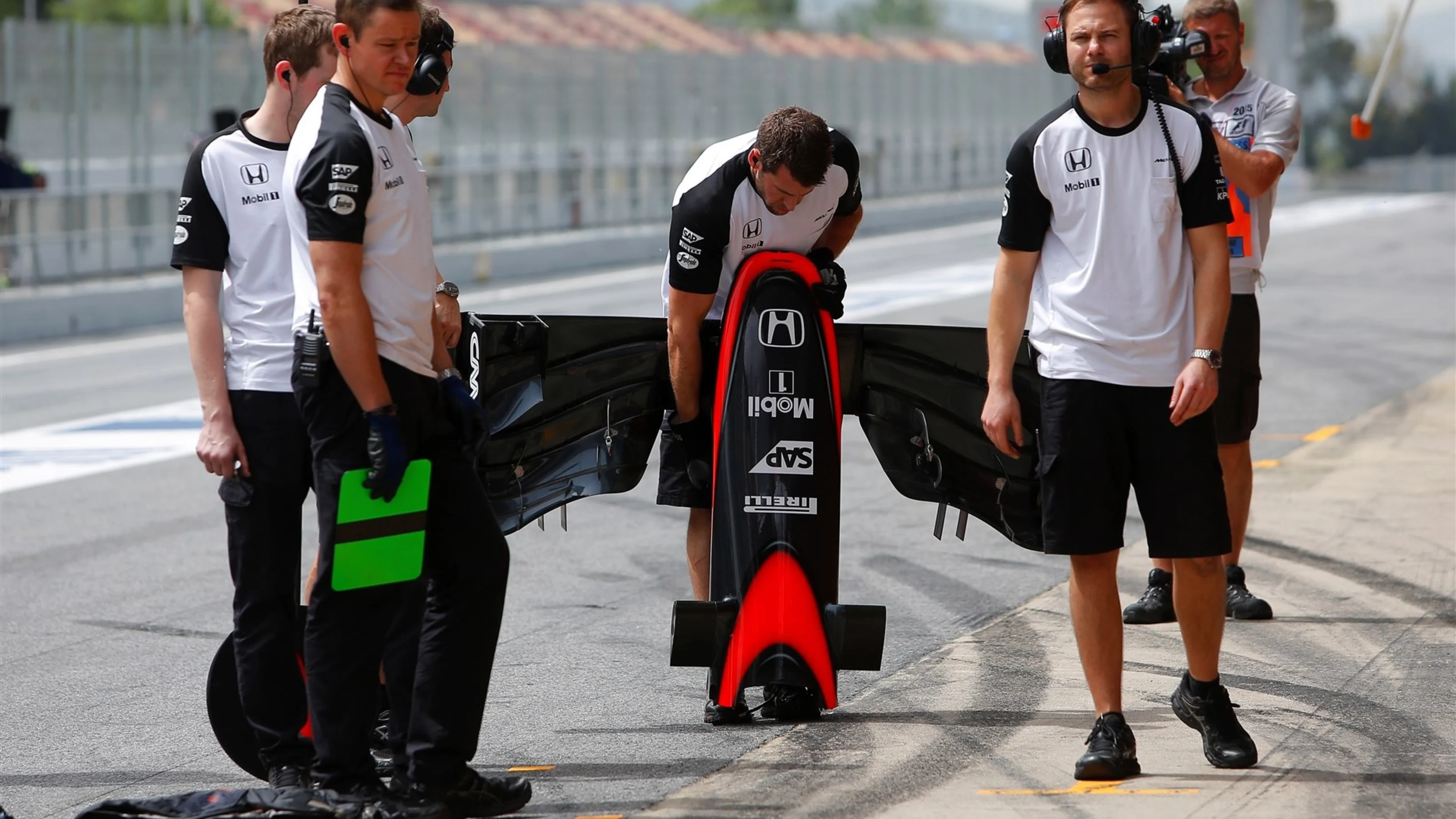 McLaren mechanics and McLaren MP4-30 front wing at Formula One Testing, Day Two, Barcelona, Spain,