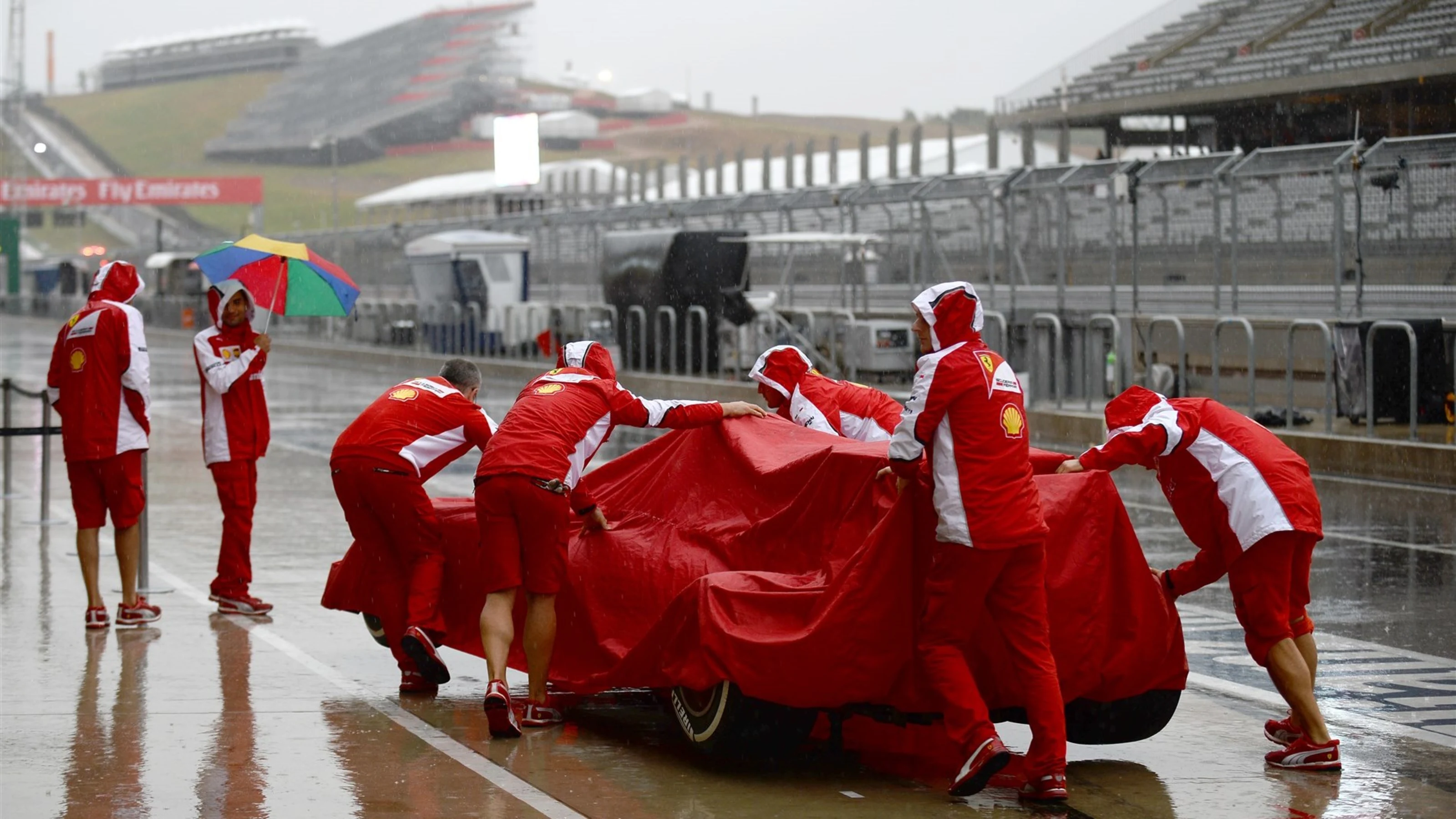 Ferrari team in the rain at Formula One World Championship, Rd16, United States Grand Prix,