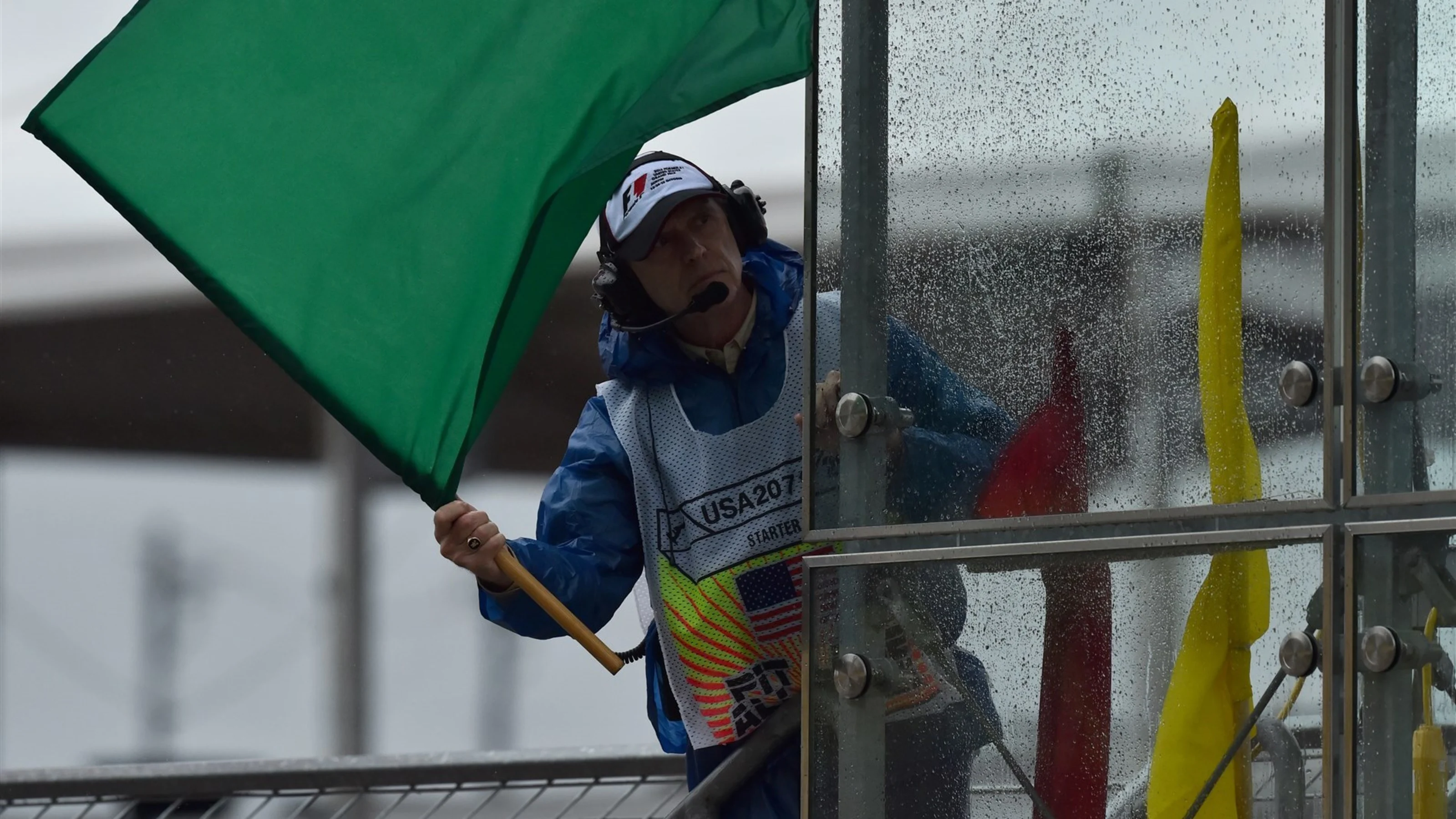 Marshal waves a green flag at Formula One World Championship, Rd16, United States Grand Prix,