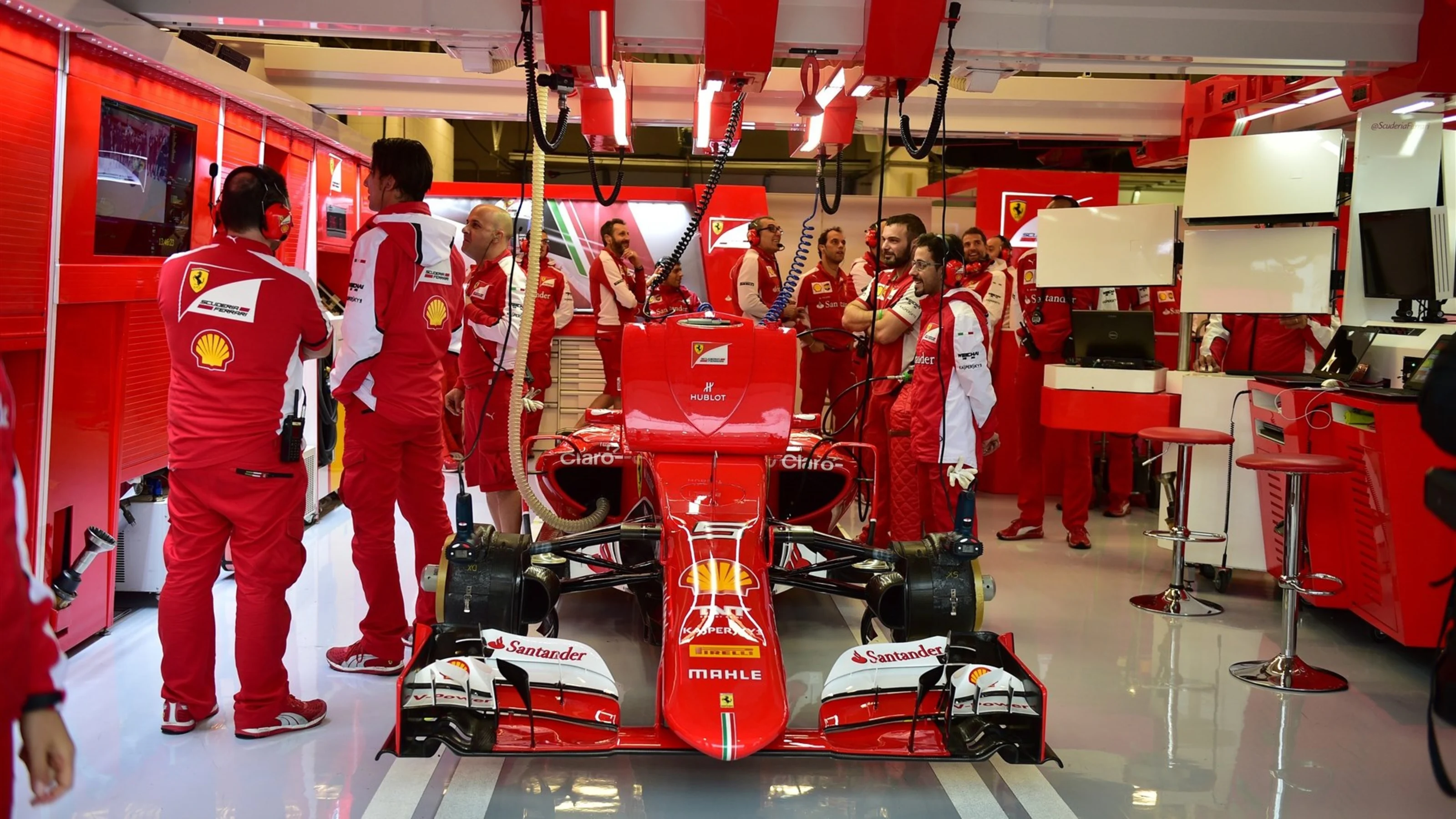 The car of Sebastian Vettel (GER) Ferrari SF15-T in the garage and Ferrari mechanics at Formula One