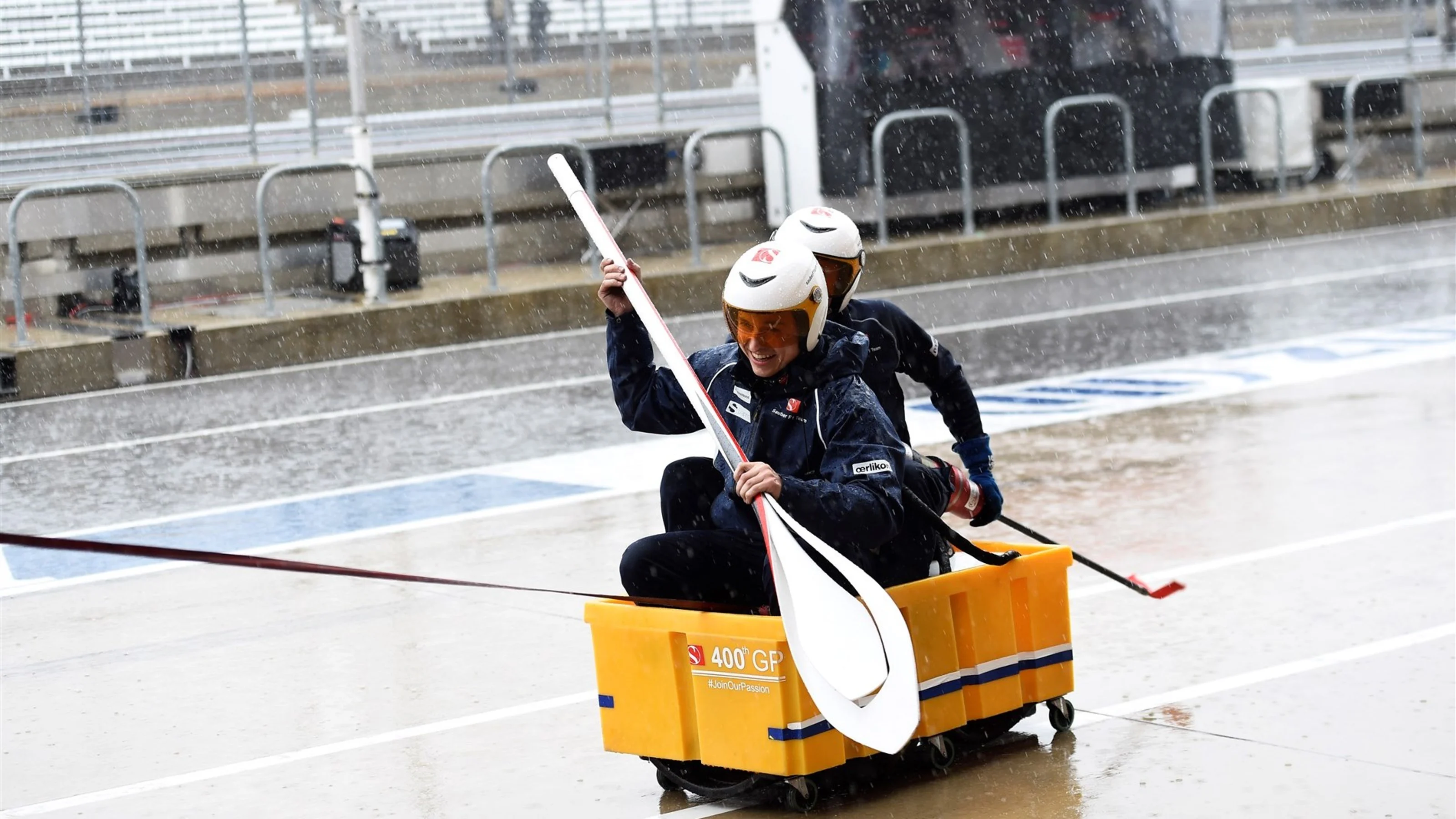 Sauber mechanics with an improvised rowing boat in pit lane at Formula One World Championship,