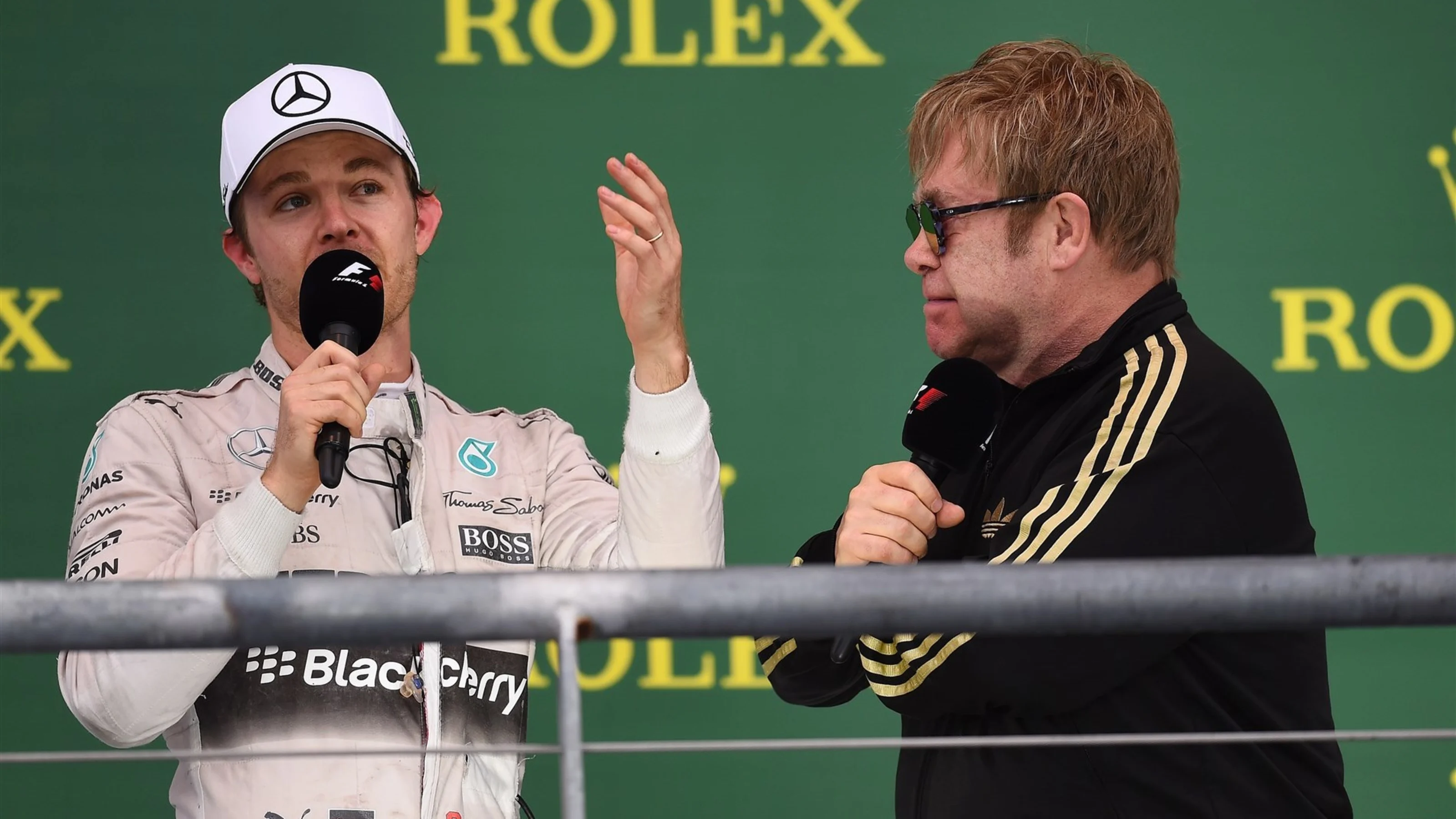Nico Rosberg (GER) Mercedes AMG F1 celebrates on the podium with Elton John (GBR) at Formula One