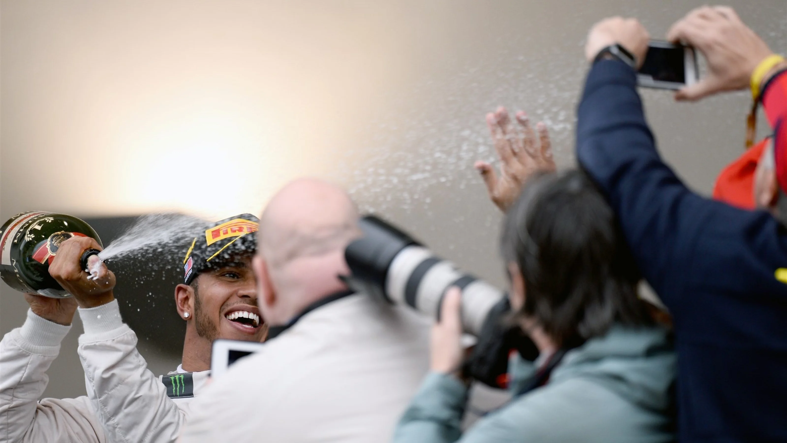 Race winner and new World Champion Lewis Hamilton (GBR) Mercedes AMG F1 celebrates on the podium at