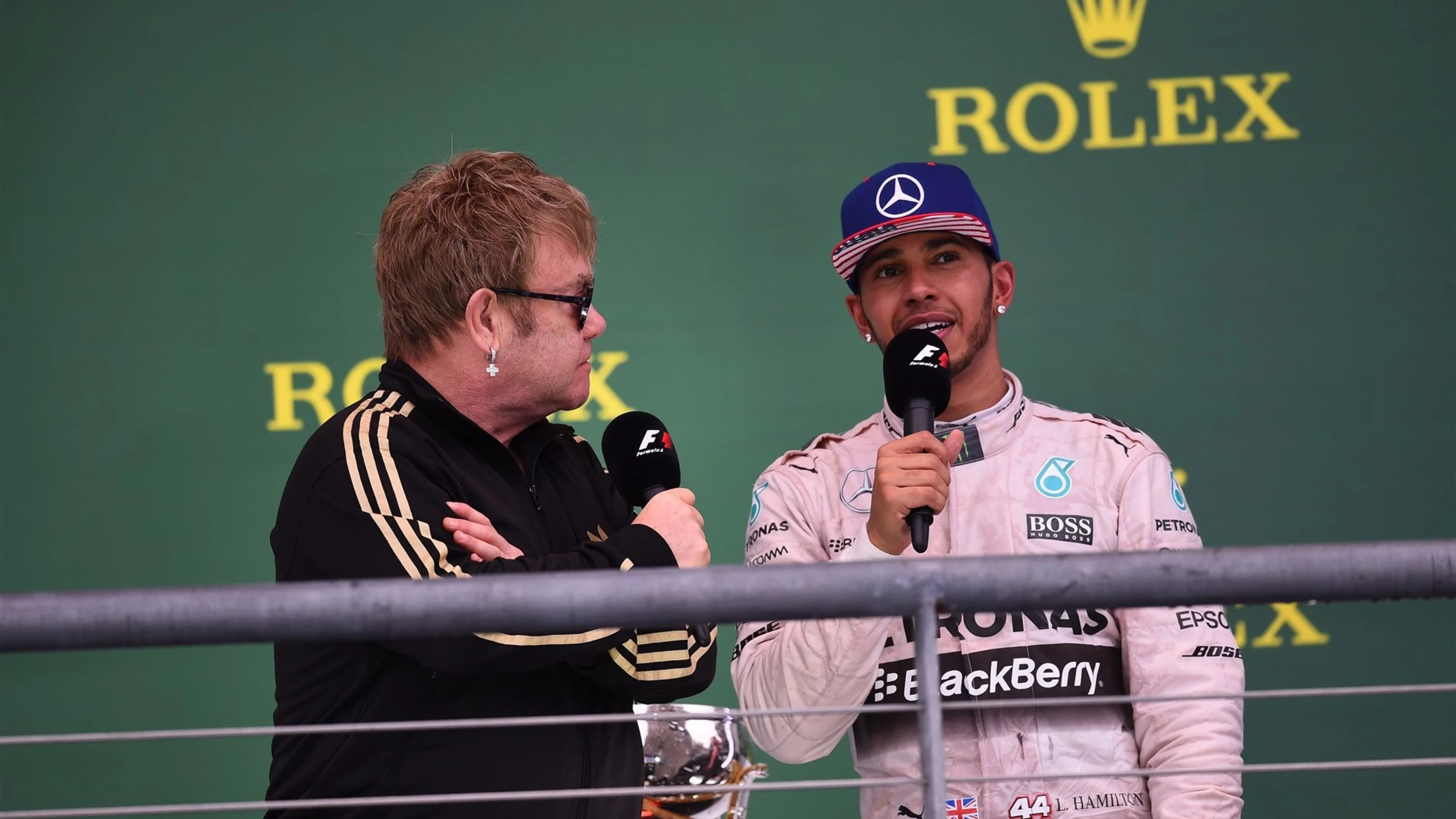 Elton John (GBR) and Lewis Hamilton (GBR) Mercedes AMG F1 on the podium at Formula One World