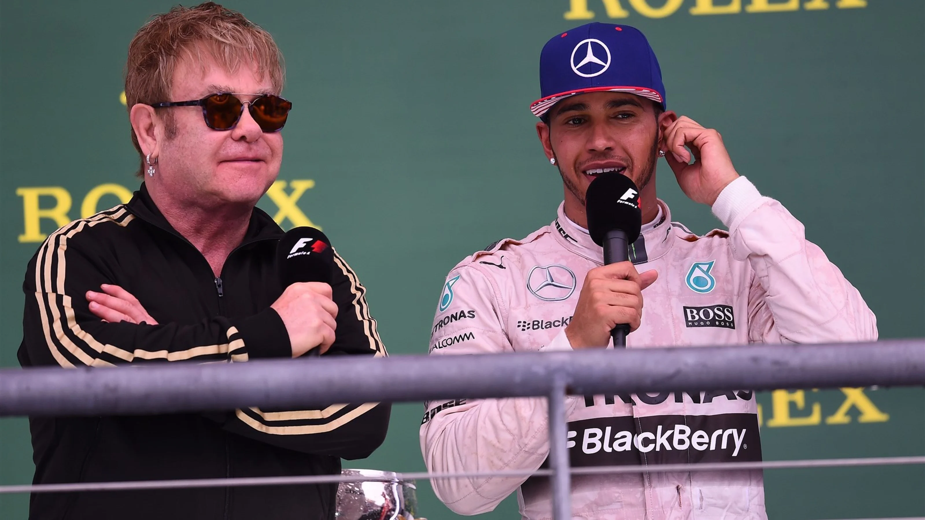 Elton John (GBR) and Lewis Hamilton (GBR) Mercedes AMG F1 on the podium at Formula One World