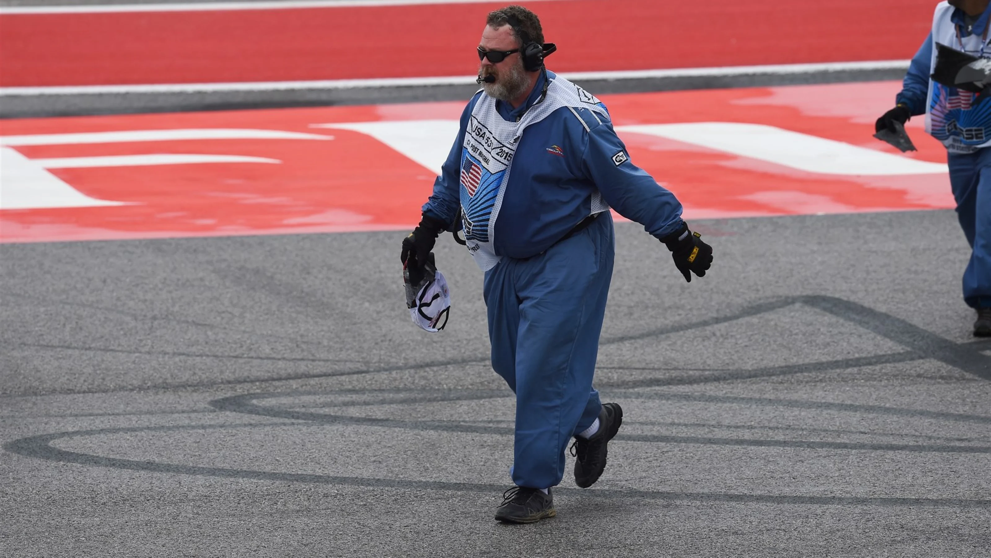 Marshals clear debris from the track at Formula One World Championship, Rd16, United States Grand