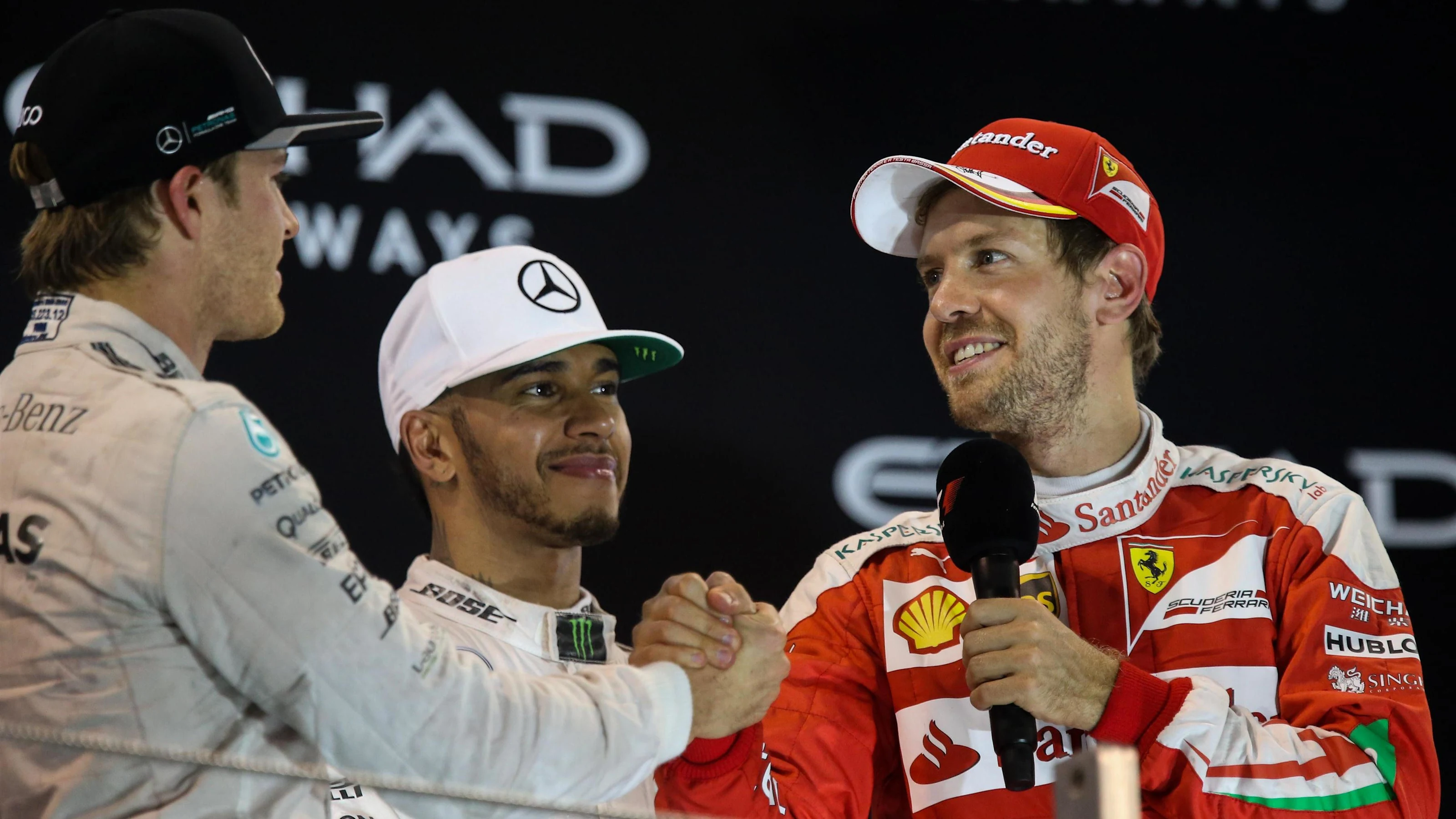 World Champion Nico Rosberg (GER) Mercedes AMG F1 celebrates on the podium with Sebastian Vettel