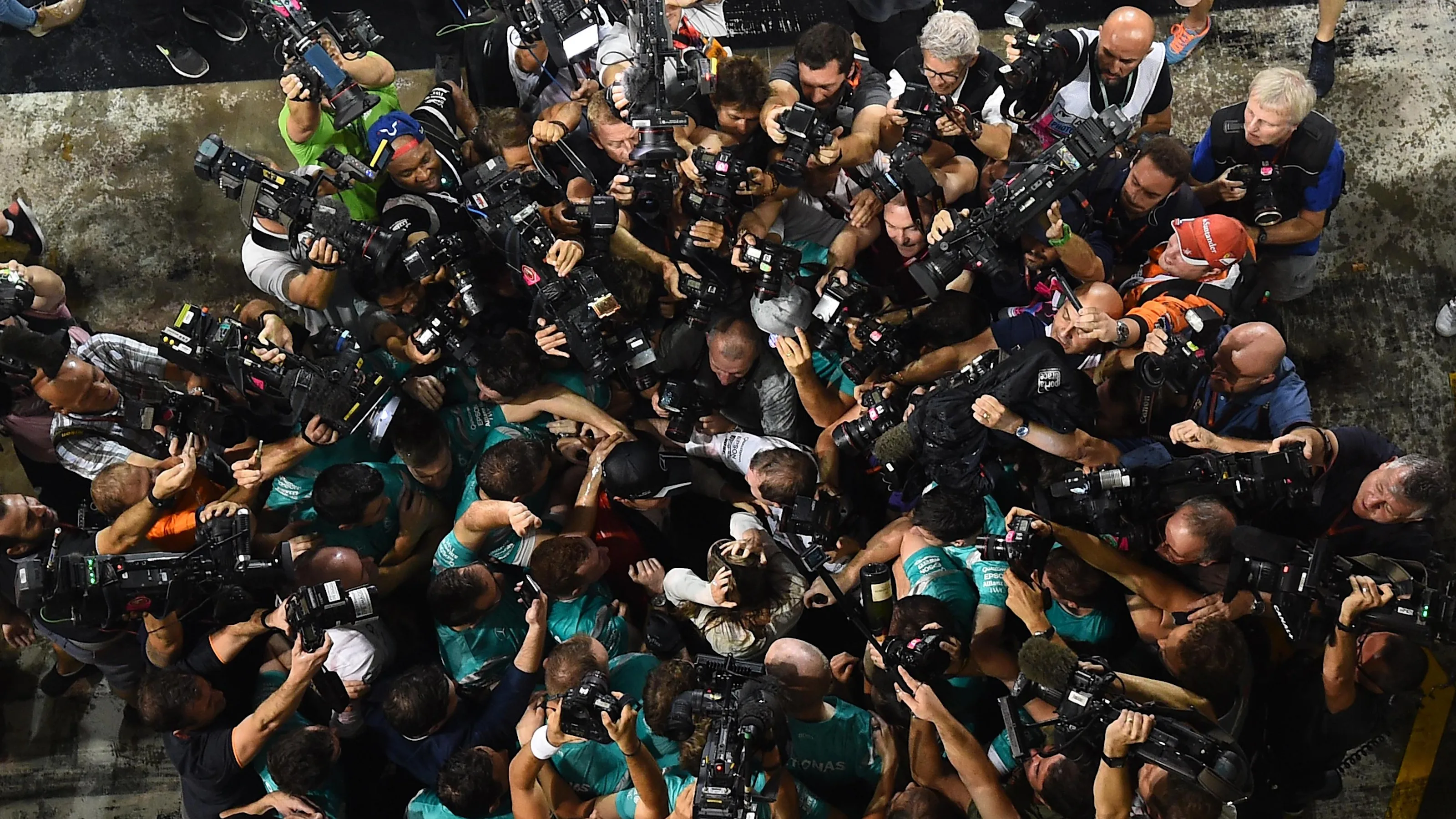 Nico Rosberg (GER) Mercedes AMG F1 celebrates with the team surrounded by photographers at Formula