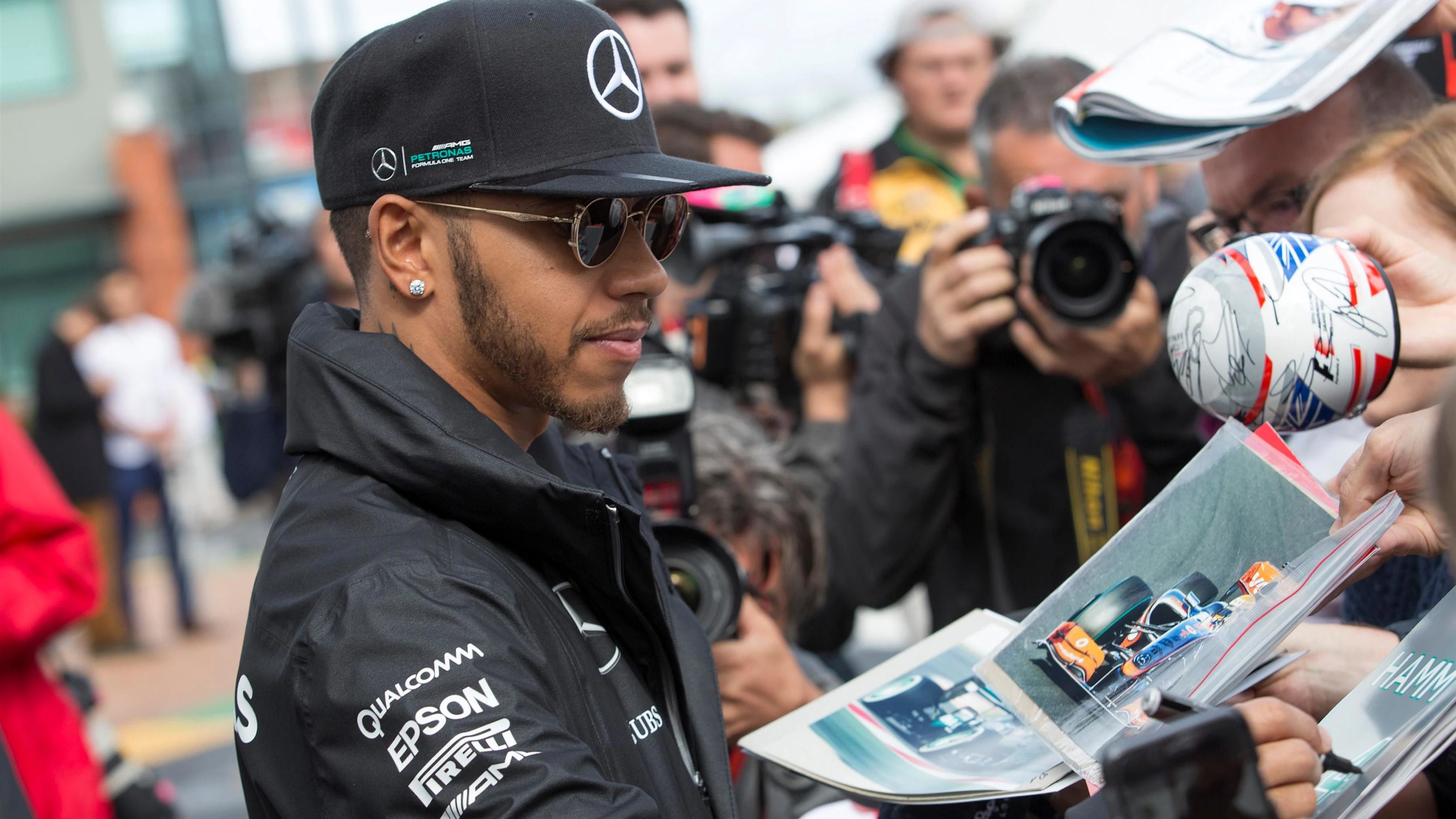 Lewis Hamilton (GBR) Mercedes AMG F1 signs autographs for the fans at Formula One World