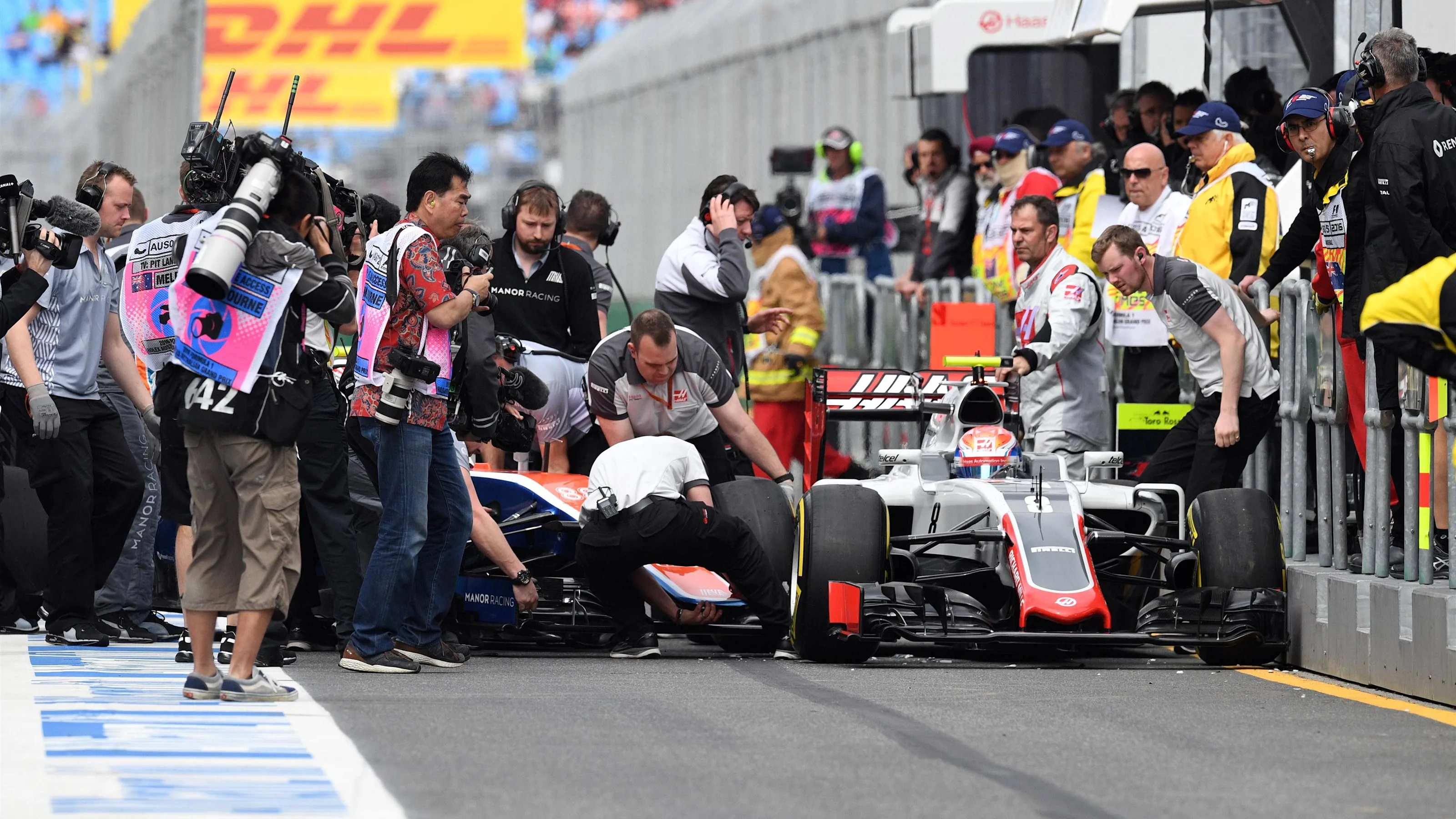 Rio Haryanto (IDN) Manor Racing MRT05 and Romain Grosjean (FRA) Haas VF-16 collide in pit lane in