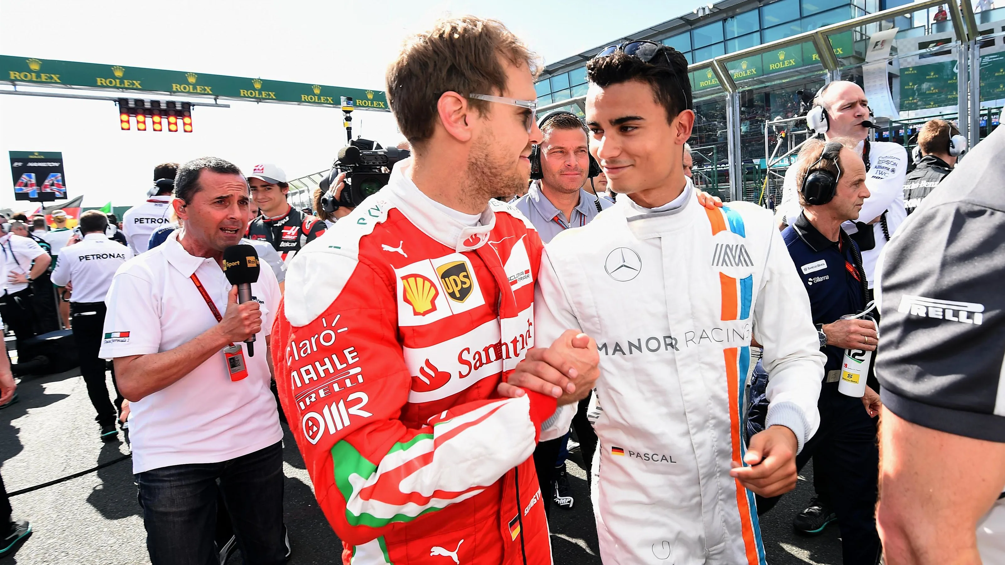 Sebastian Vettel (GER) Ferrari and Pascal Wehrlein (GER) Manor Racing on the grid at Formula One