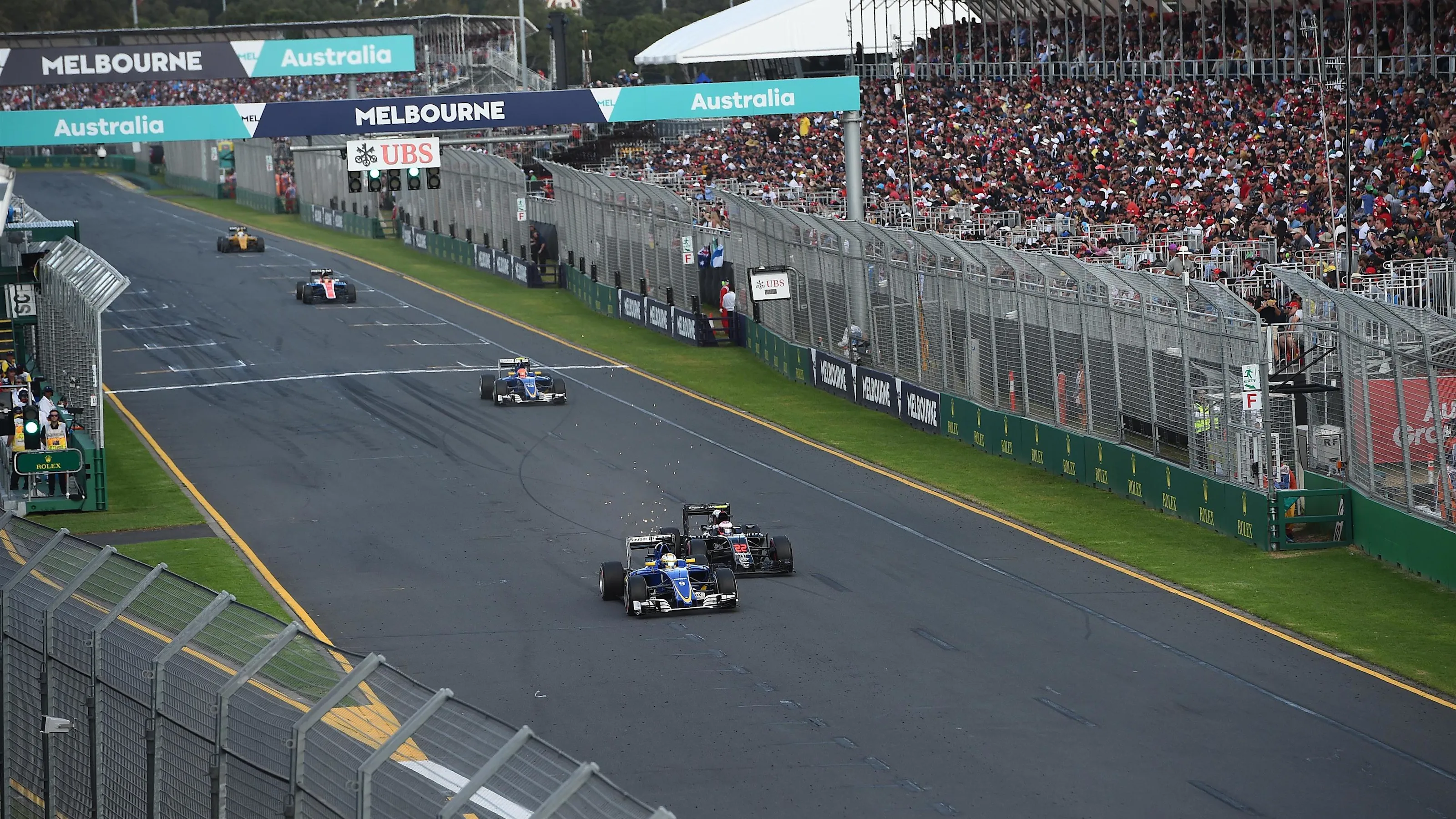 Marcus Ericsson (SWE) Sauber C35 Jenson Button (GBR) McLaren MP4-31 battle and at Formula One World