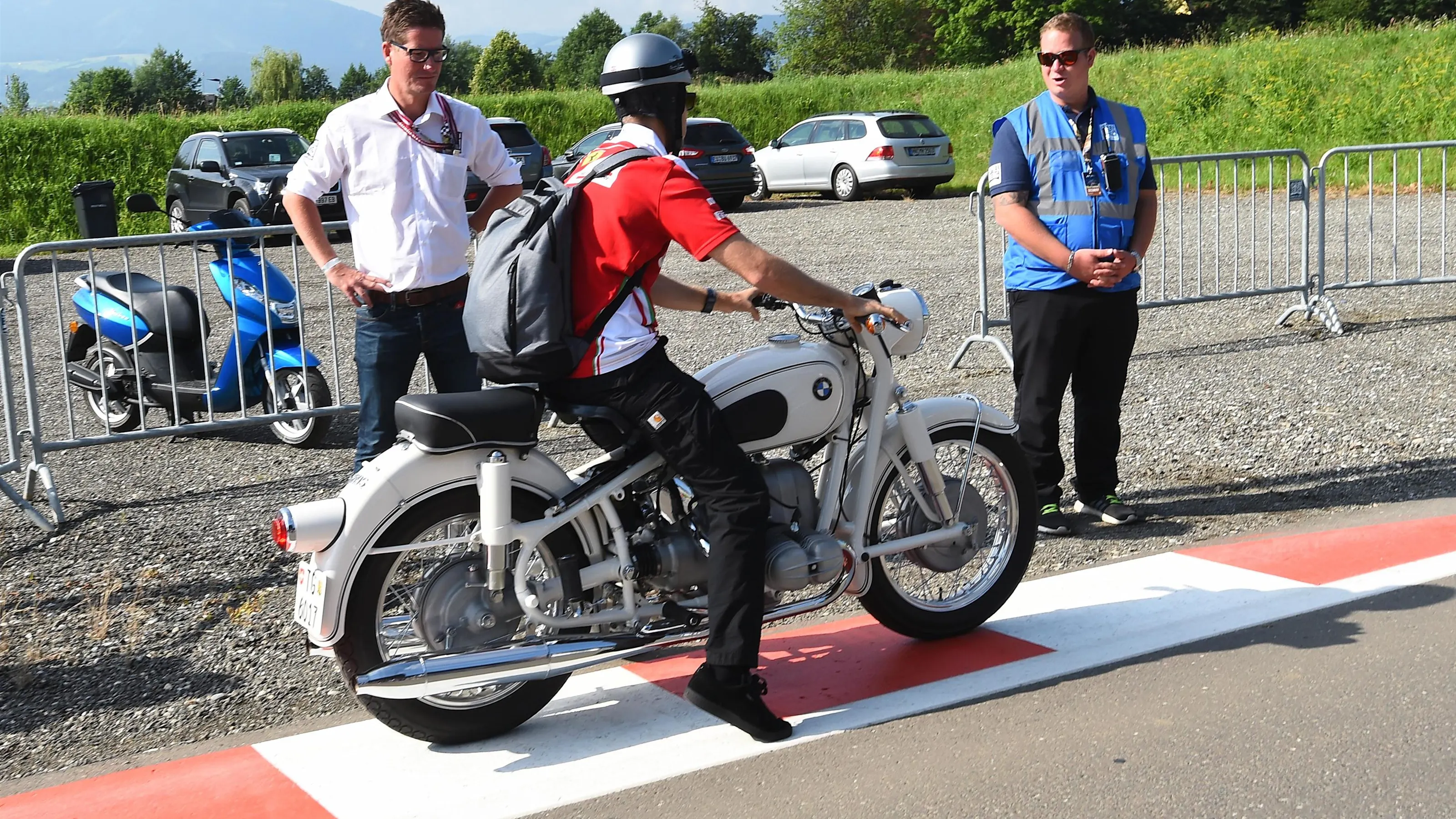 Sebastian Vettel (GER) Ferrari arrives at the track on a vintage BMW motorbike at Formula One World