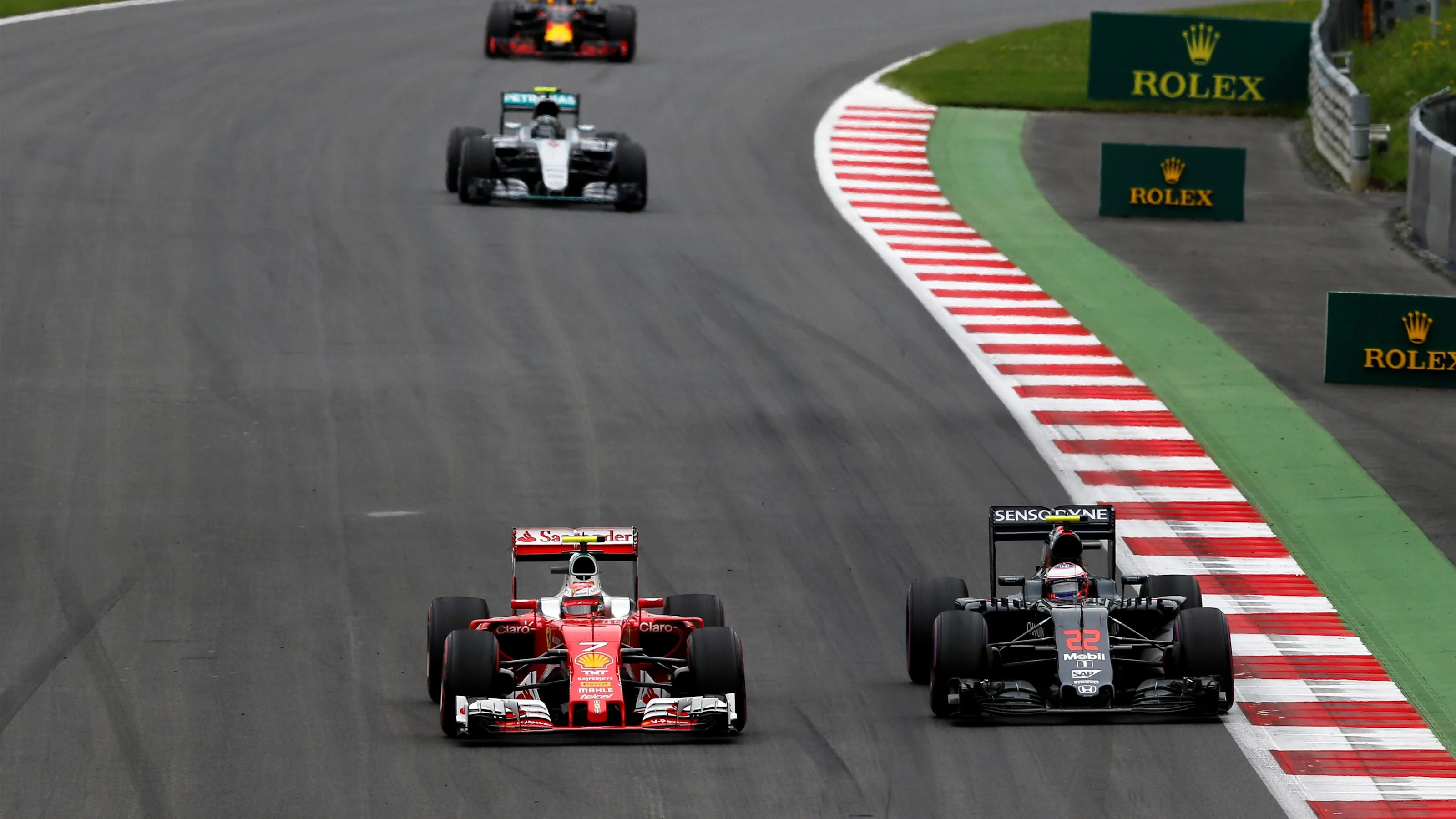 Kimi Raikkonen (FIN) Ferrari SF16-H passes Jenson Button (GBR) McLaren MP4-31 at Formula One World