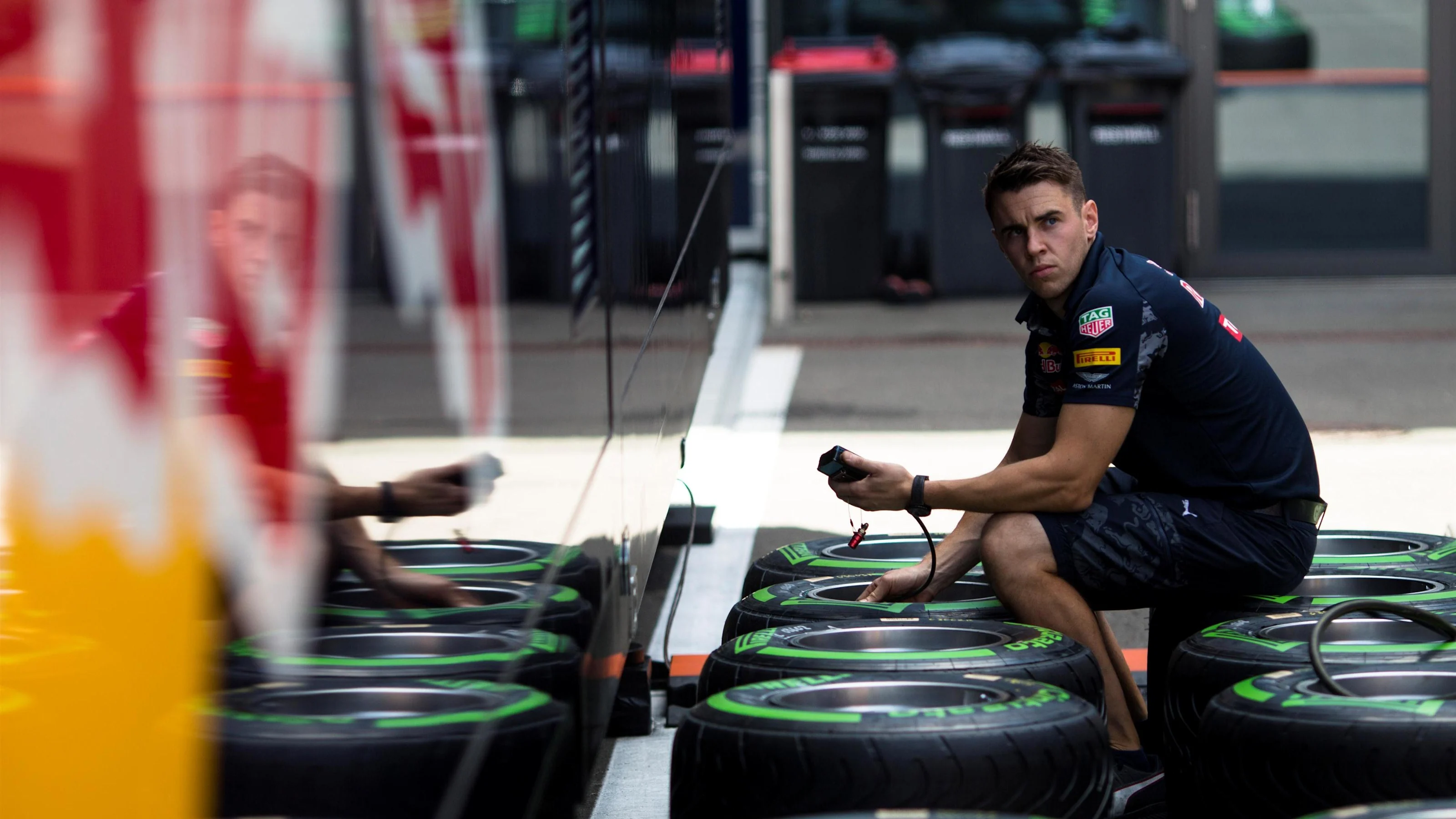 Red Bull Racing mechanic and Pirelli tyres at Formula One World Championship, Rd9, Austrian Grand